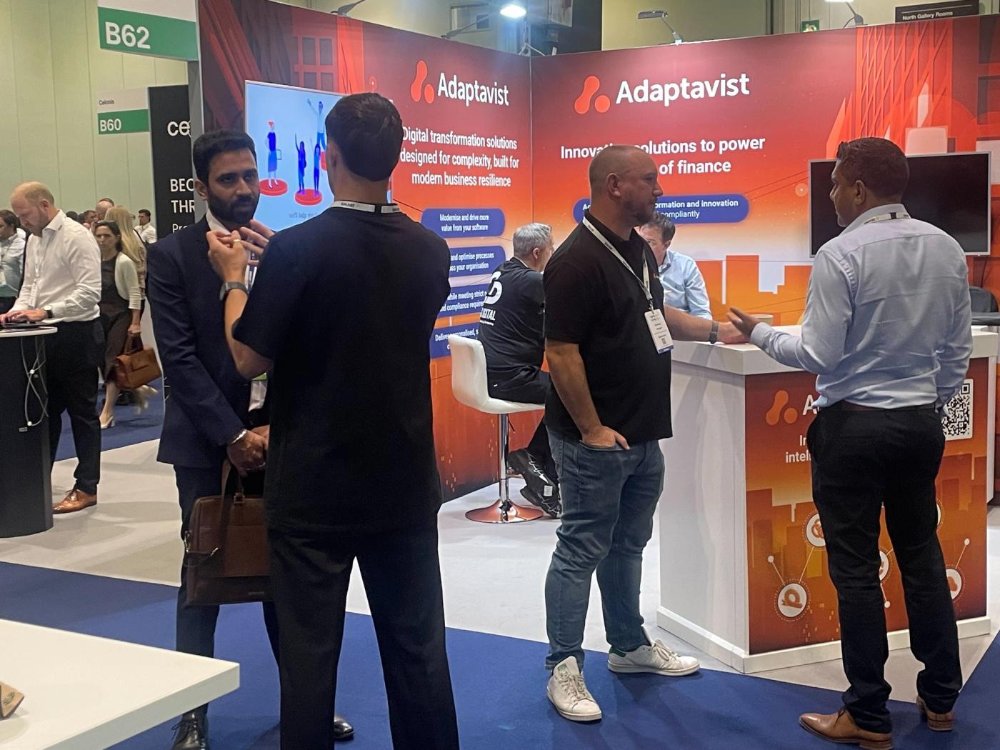 Adaptavist booth with employees talking to customers
