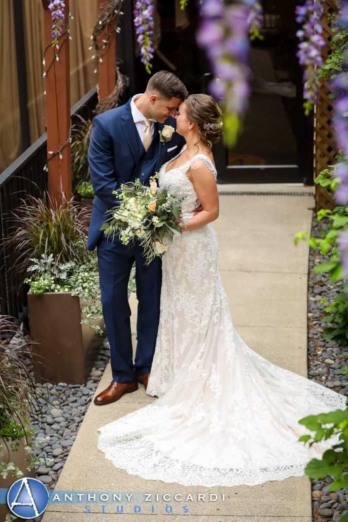 Bride wearing a fitted lace wedding gown purchased at Aleana’s Bridal.
