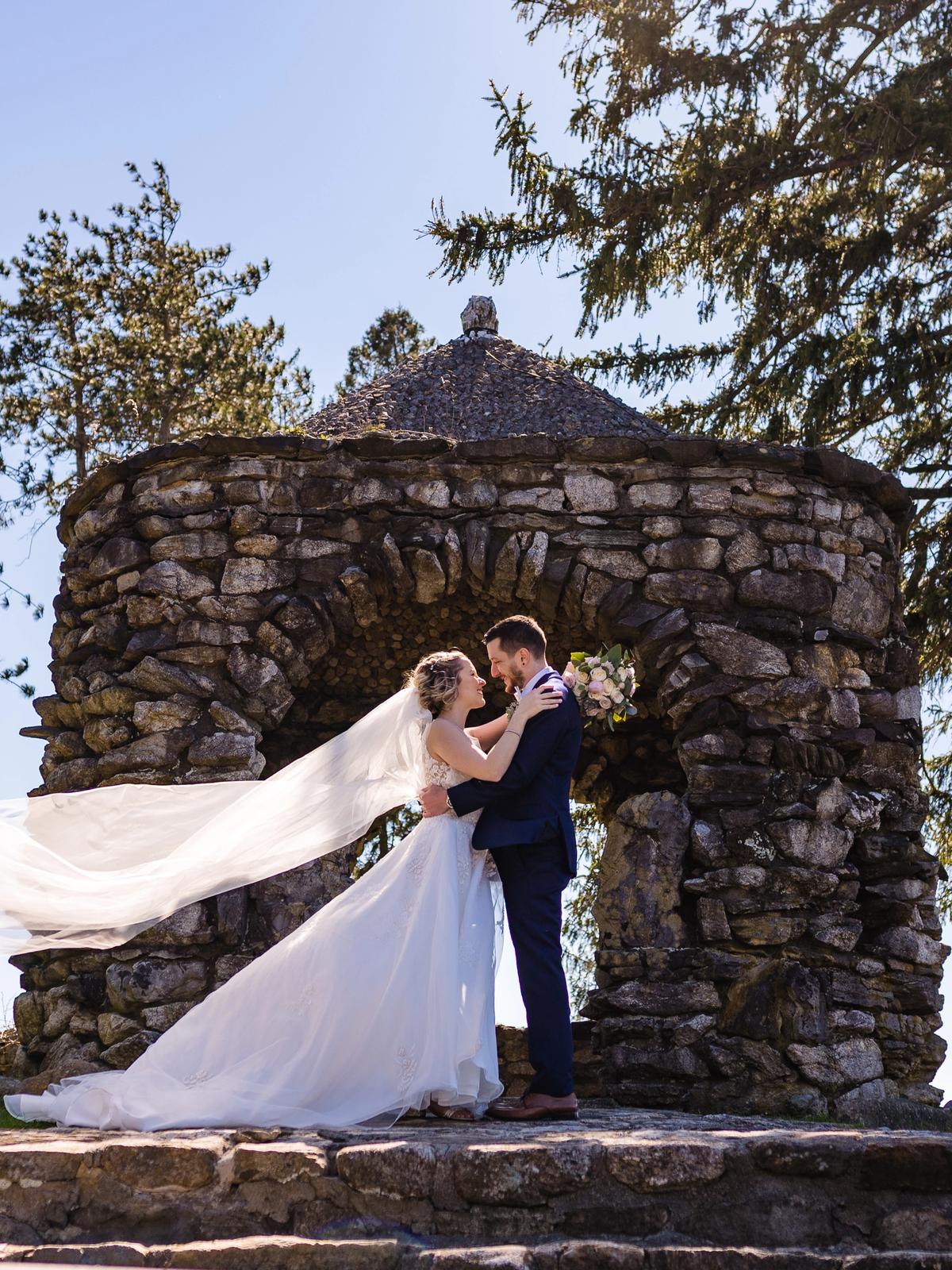 Bride posing outdoors in a luxury designer wedding dress from Aleana’s Bridal