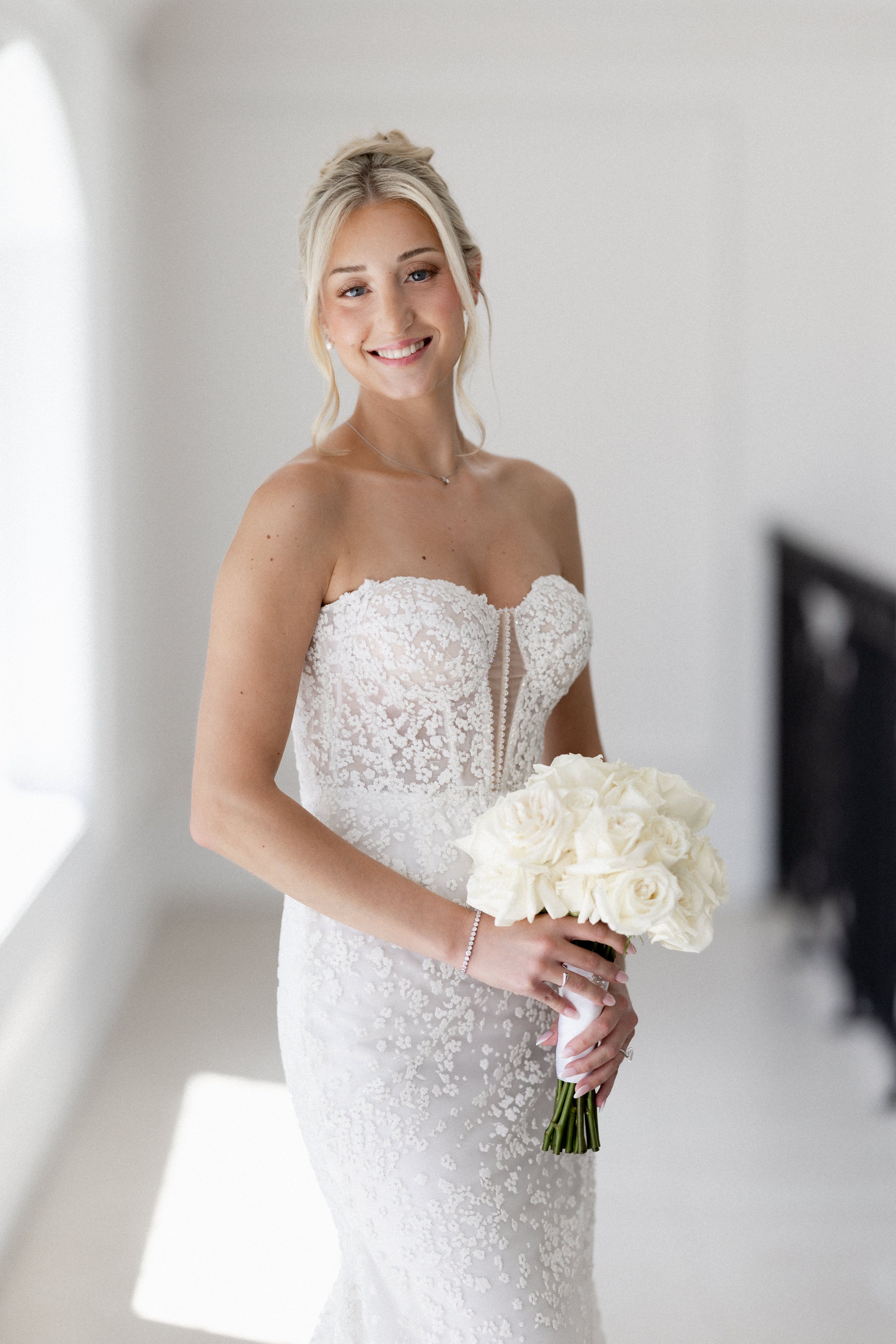 Romantic bridal portrait featuring a designer wedding gown from Aleana’s Bridal.