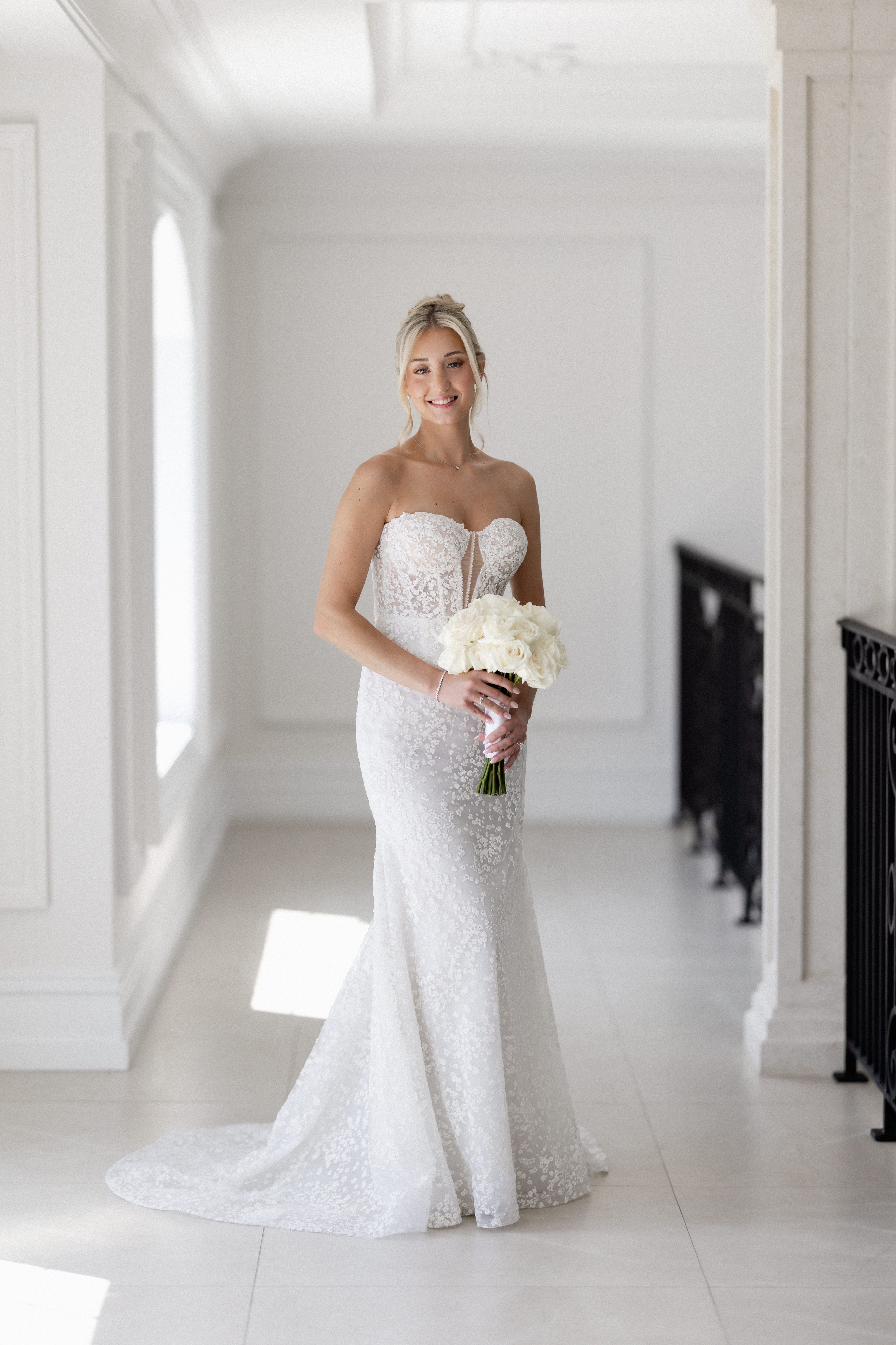 Romantic bridal portrait featuring a designer wedding gown from Aleana’s Bridal.