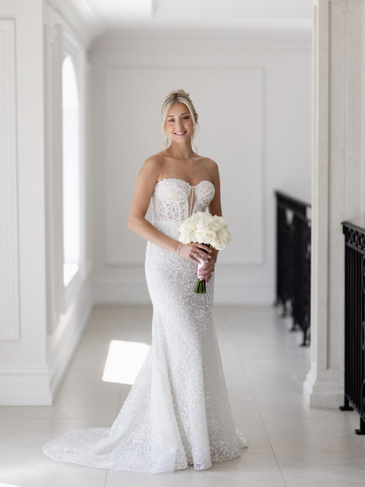 Romantic bridal portrait featuring a designer wedding gown from Aleana’s Bridal.