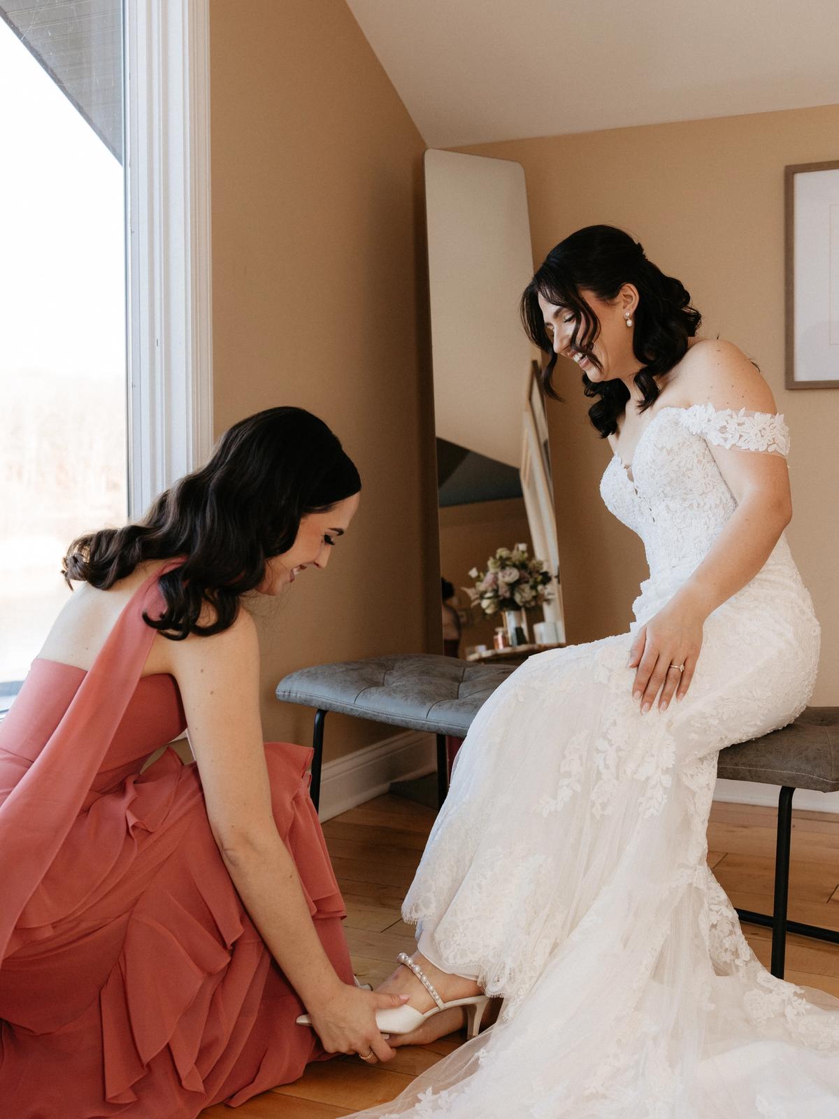 Bride wearing a fitted lace wedding gown purchased at Aleana’s Bridal.