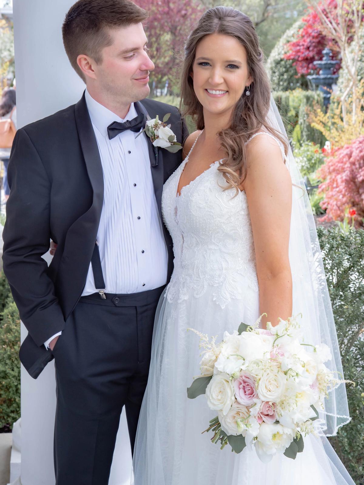 Bride wearing a couture wedding dress with lace detailing from Aleana’s Bridal