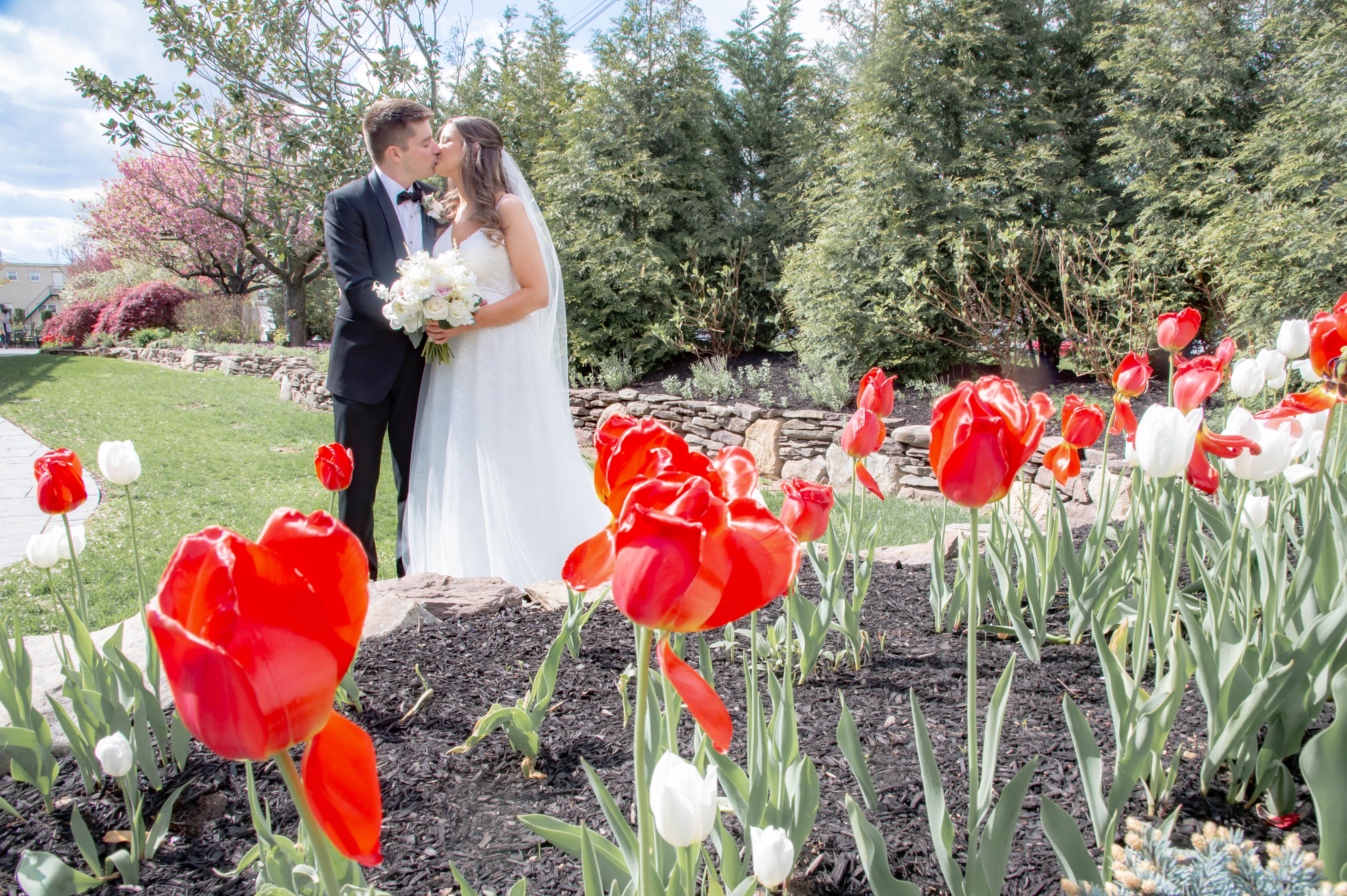 Bride posing outdoors in a luxury designer wedding dress from Aleana’s Bridal