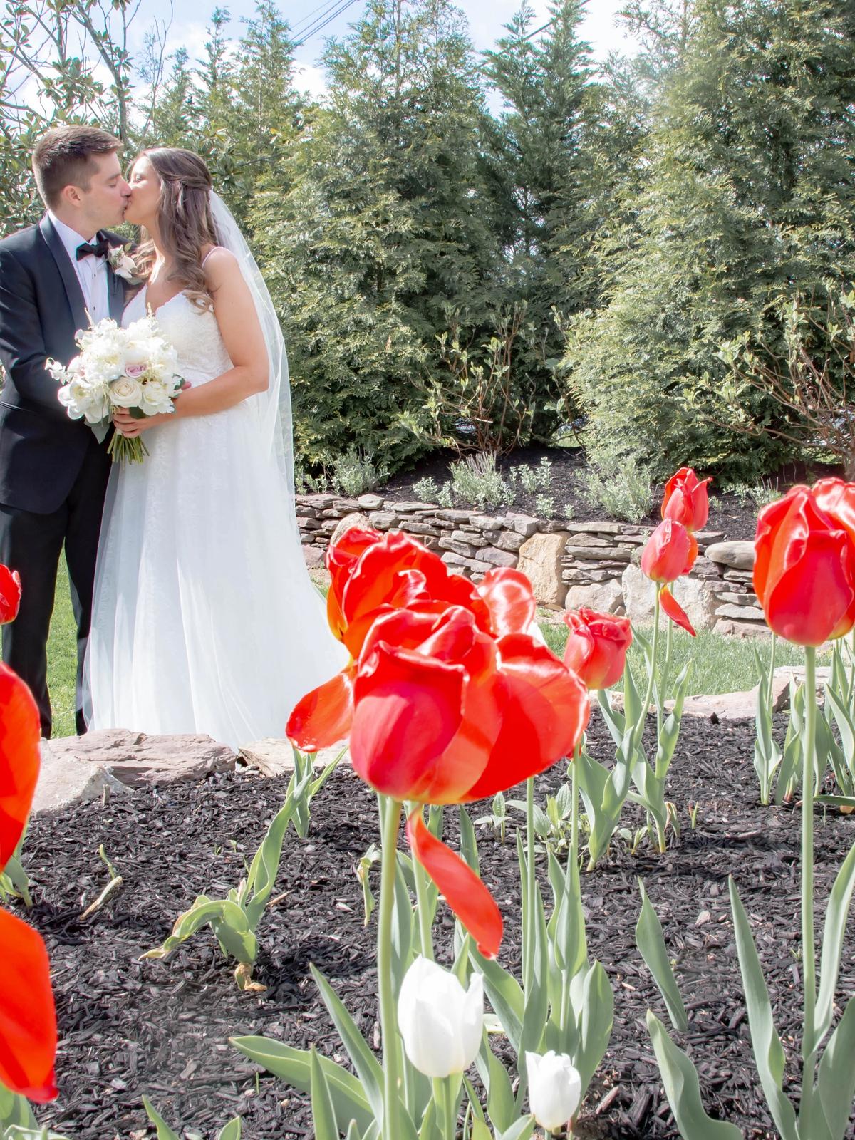 Bride posing outdoors in a luxury designer wedding dress from Aleana’s Bridal