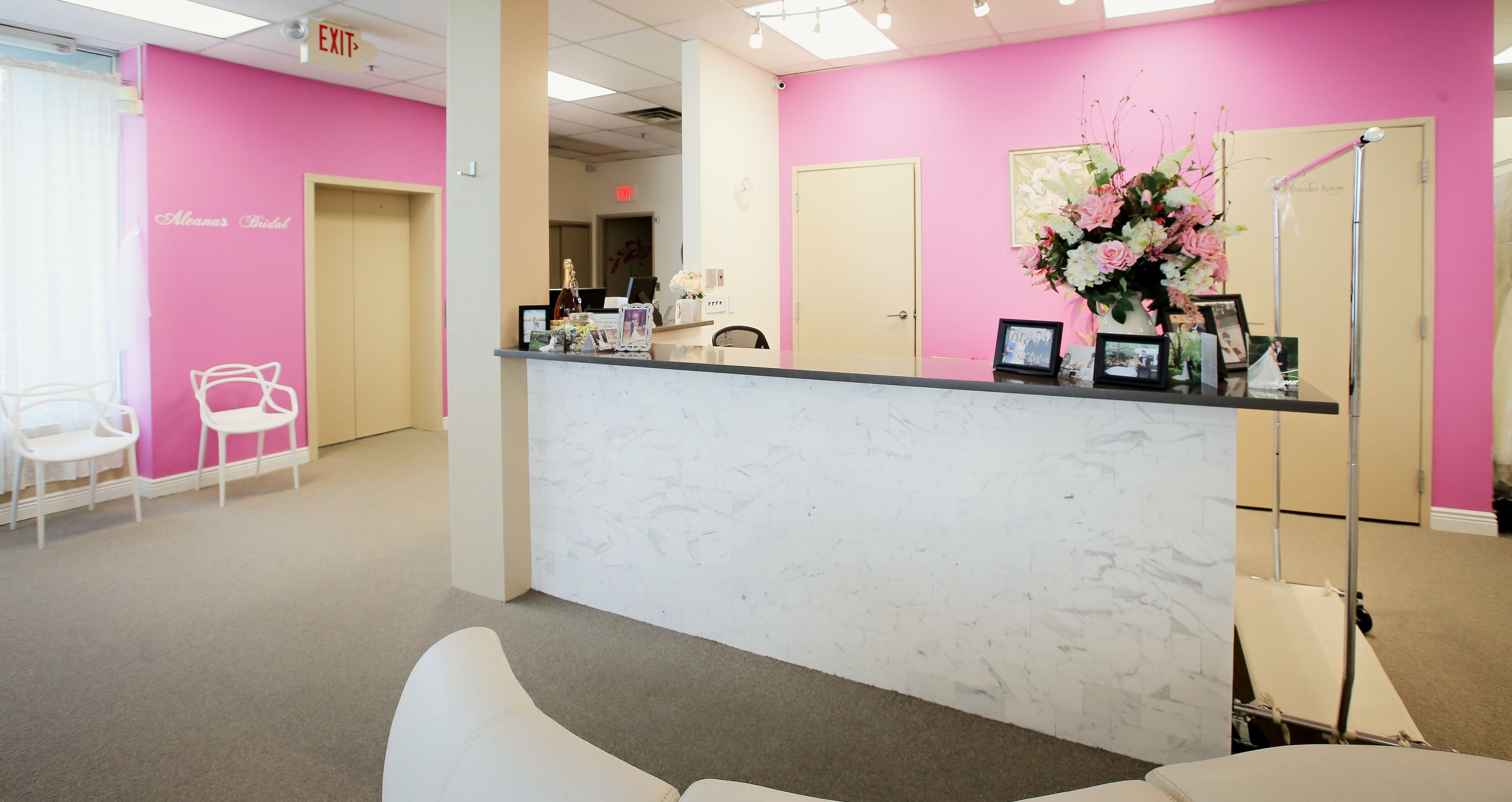 The reception desk and pink walls at Aleana's Bridal
