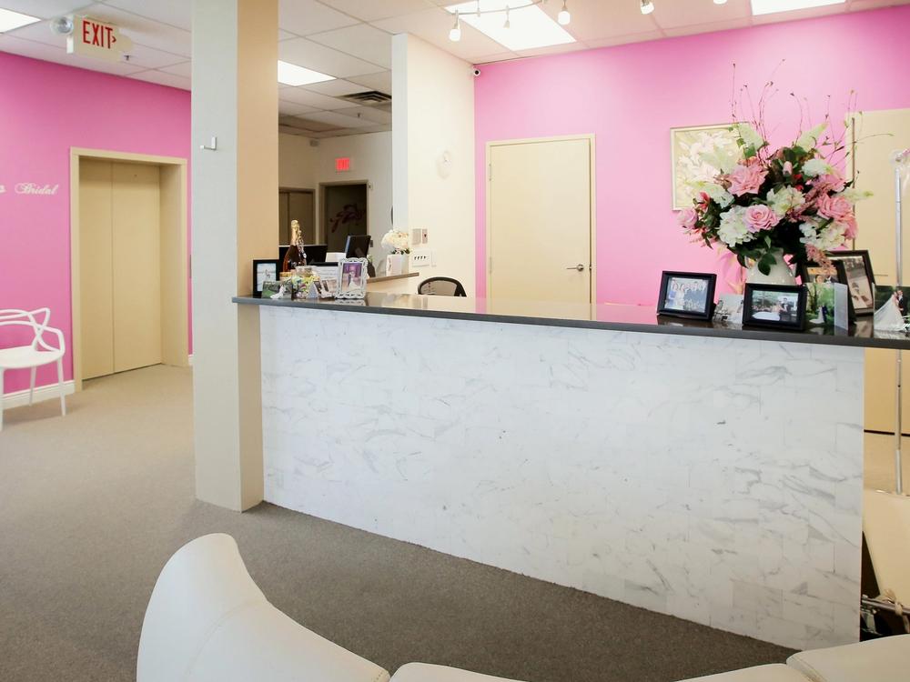 The reception desk and pink walls at Aleana's Bridal