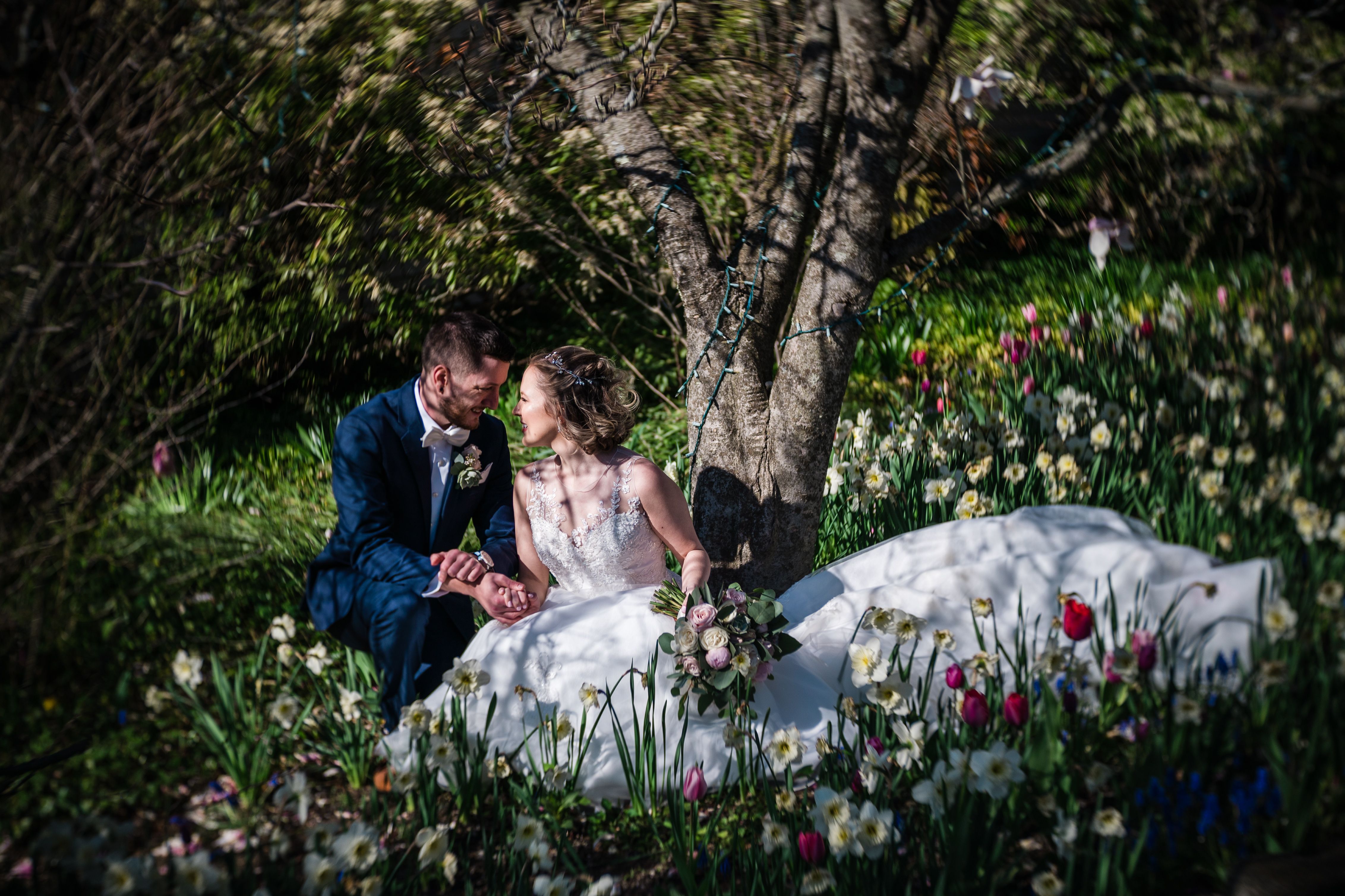 Bride posing outdoors in a luxury designer wedding dress from Aleana’s Bridal