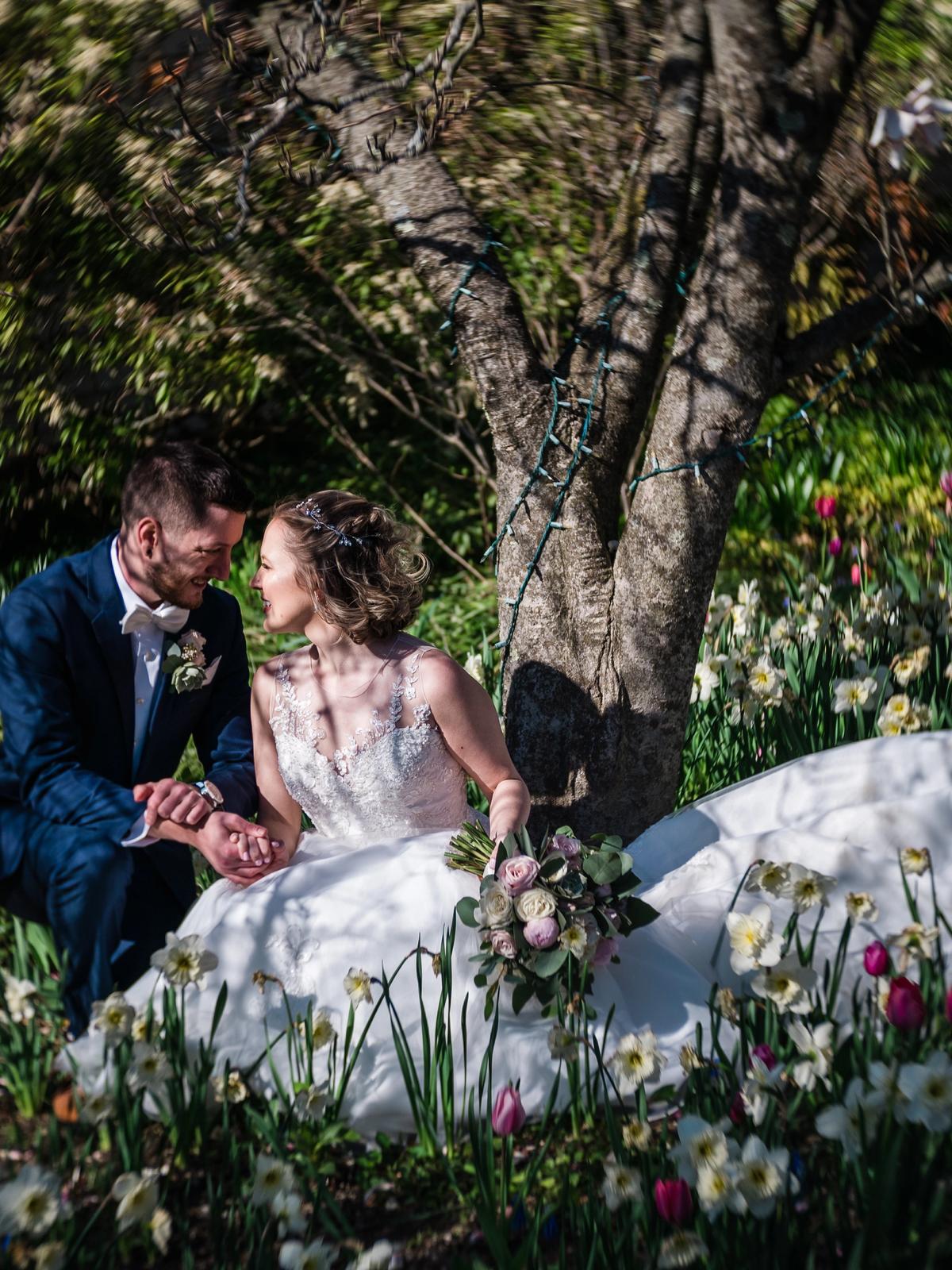 Bride posing outdoors in a luxury designer wedding dress from Aleana’s Bridal