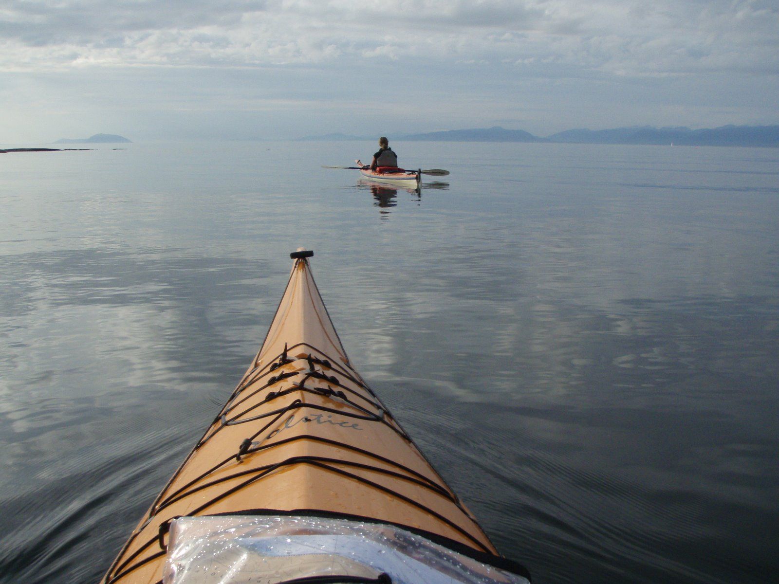 Two people kayak on deep water
