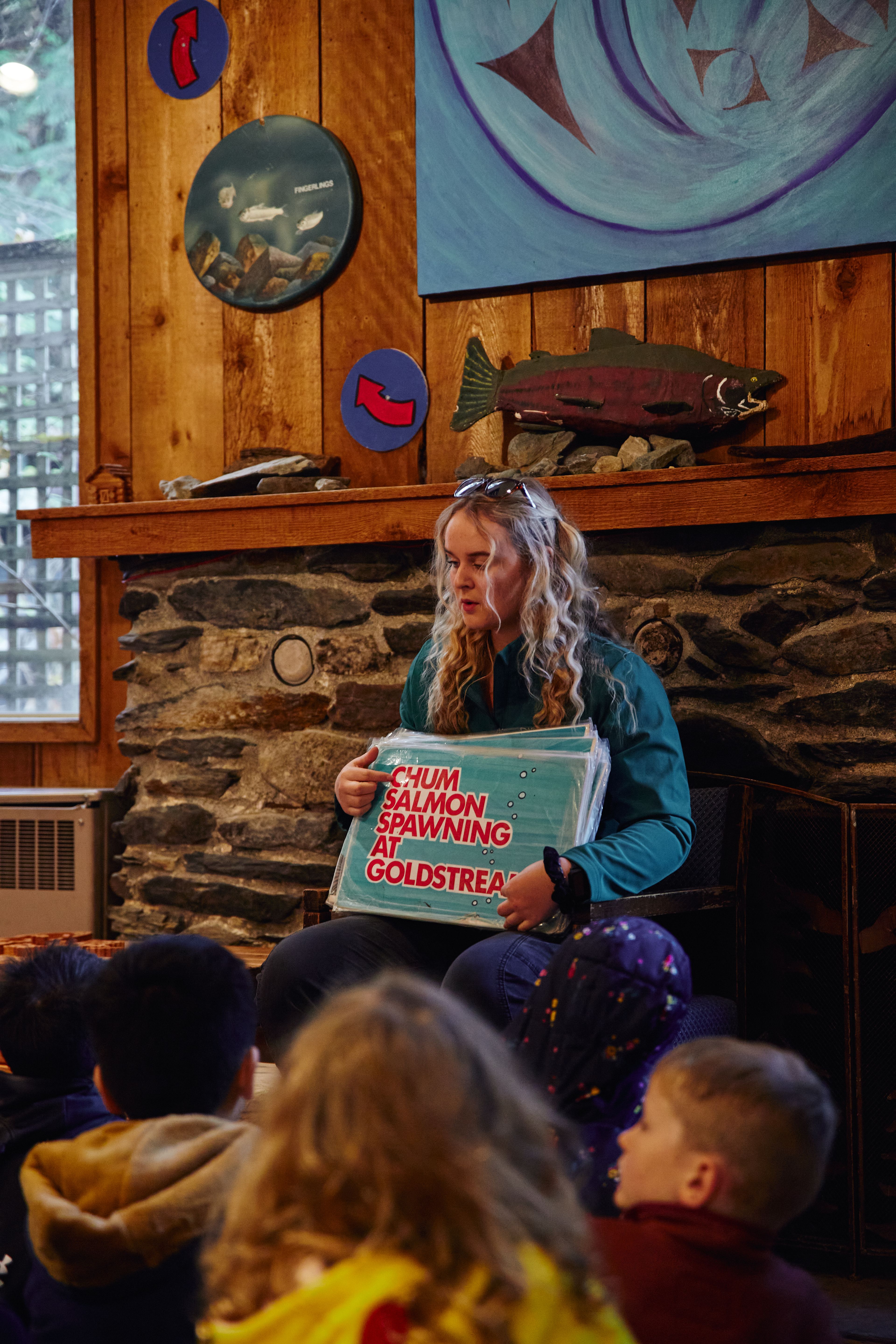 Discover Parks Ambassador holds up a leaflet saying "Chum Spawning at Goldstream"