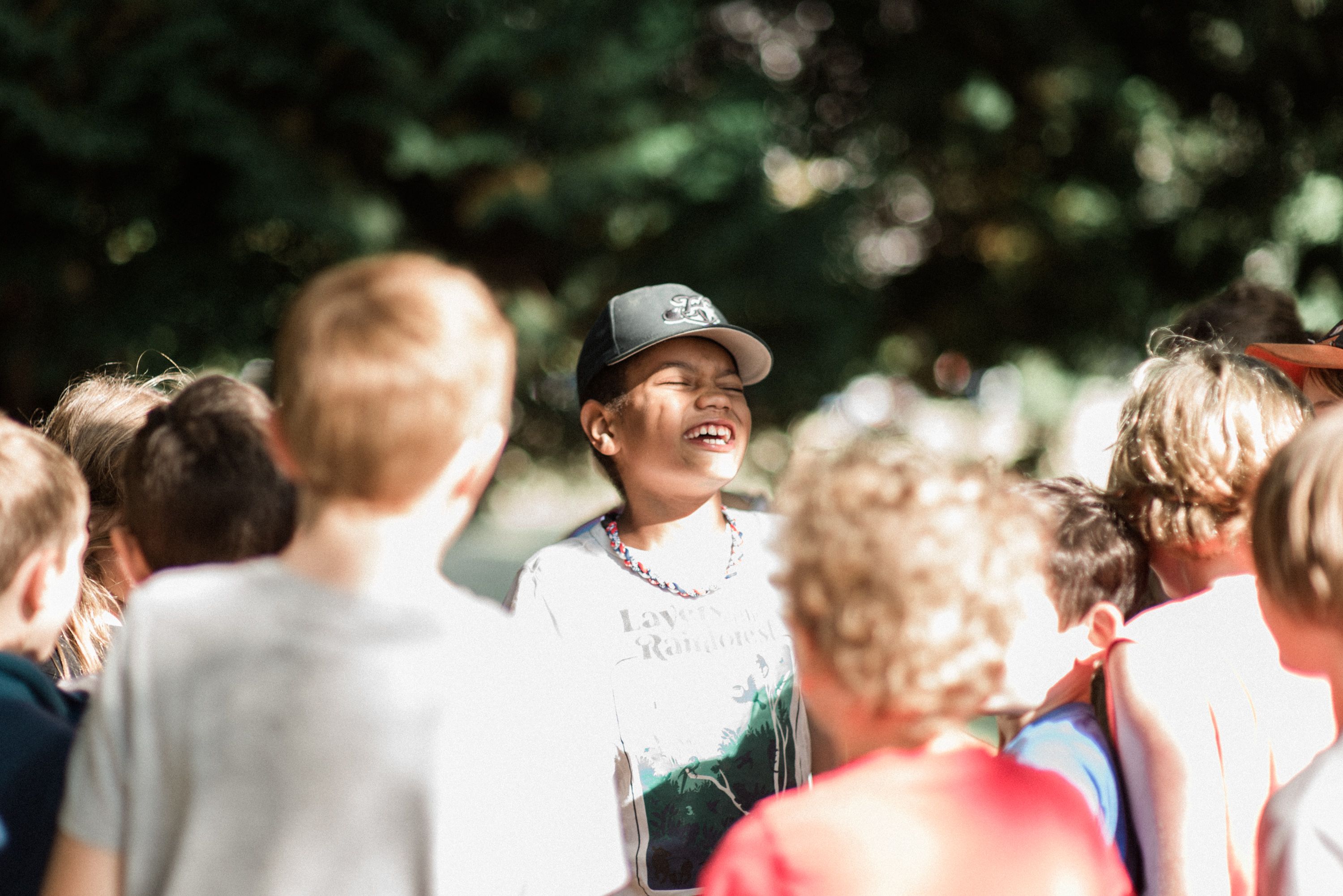 A child laughs in a group setting
