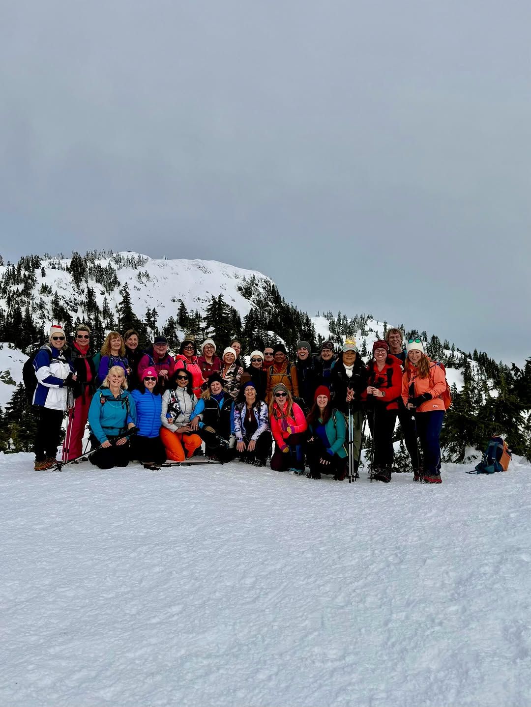 Group of hikers in snow pose for camera