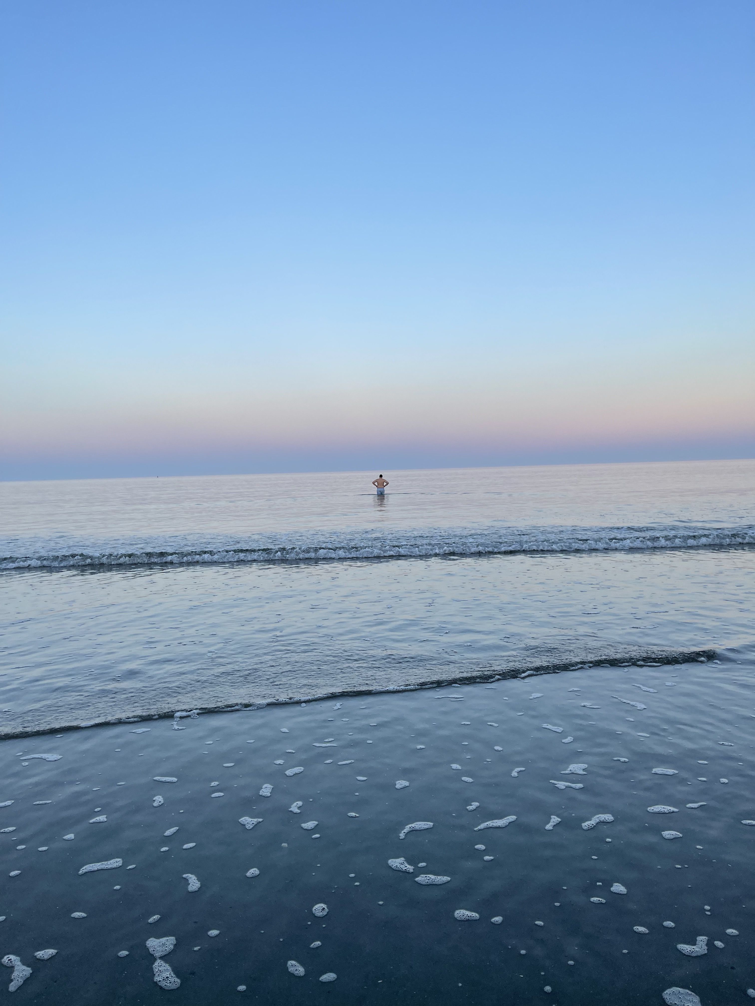 Man wades into ocean