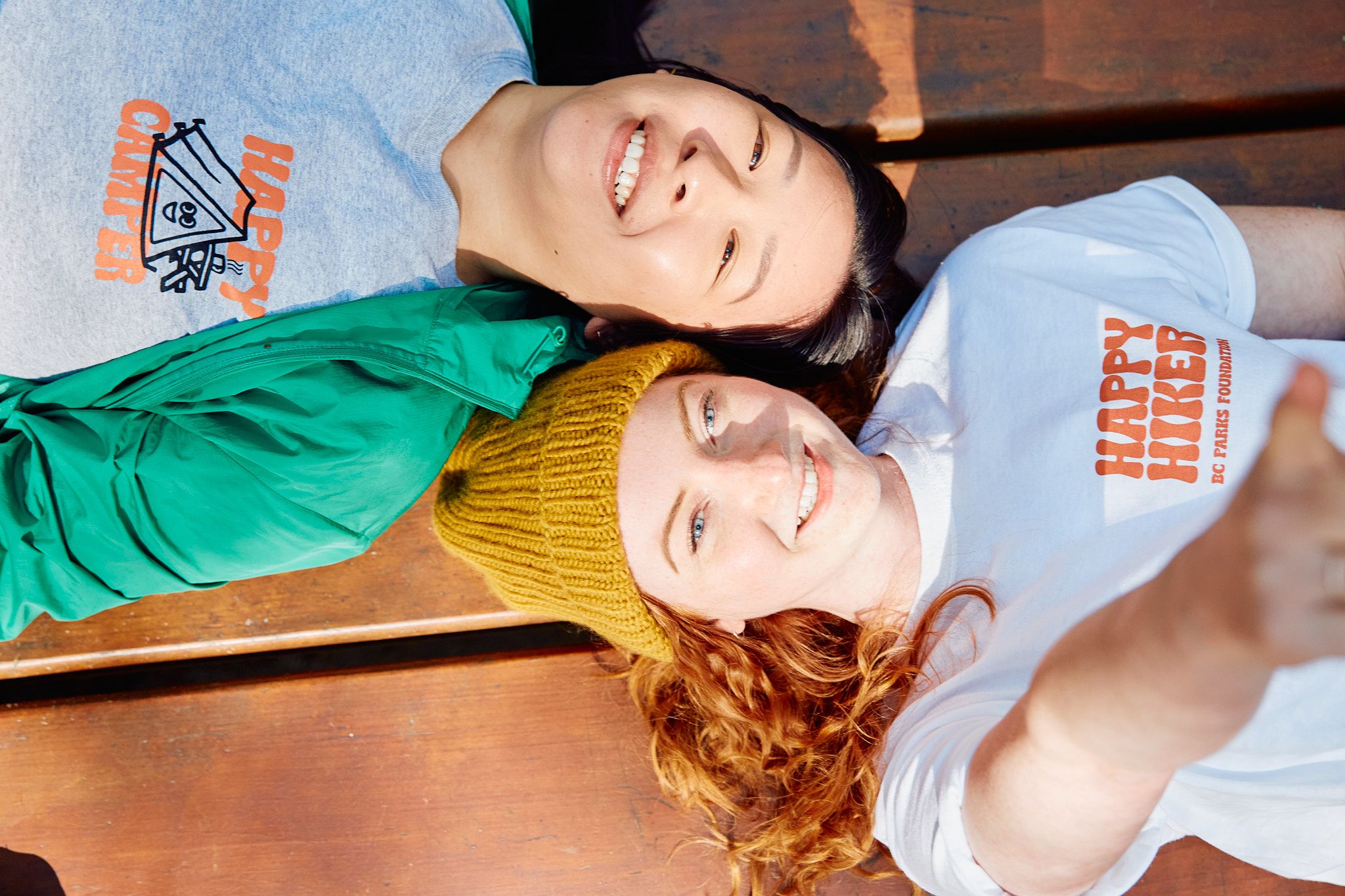 Two people model Happy Hiker merch
