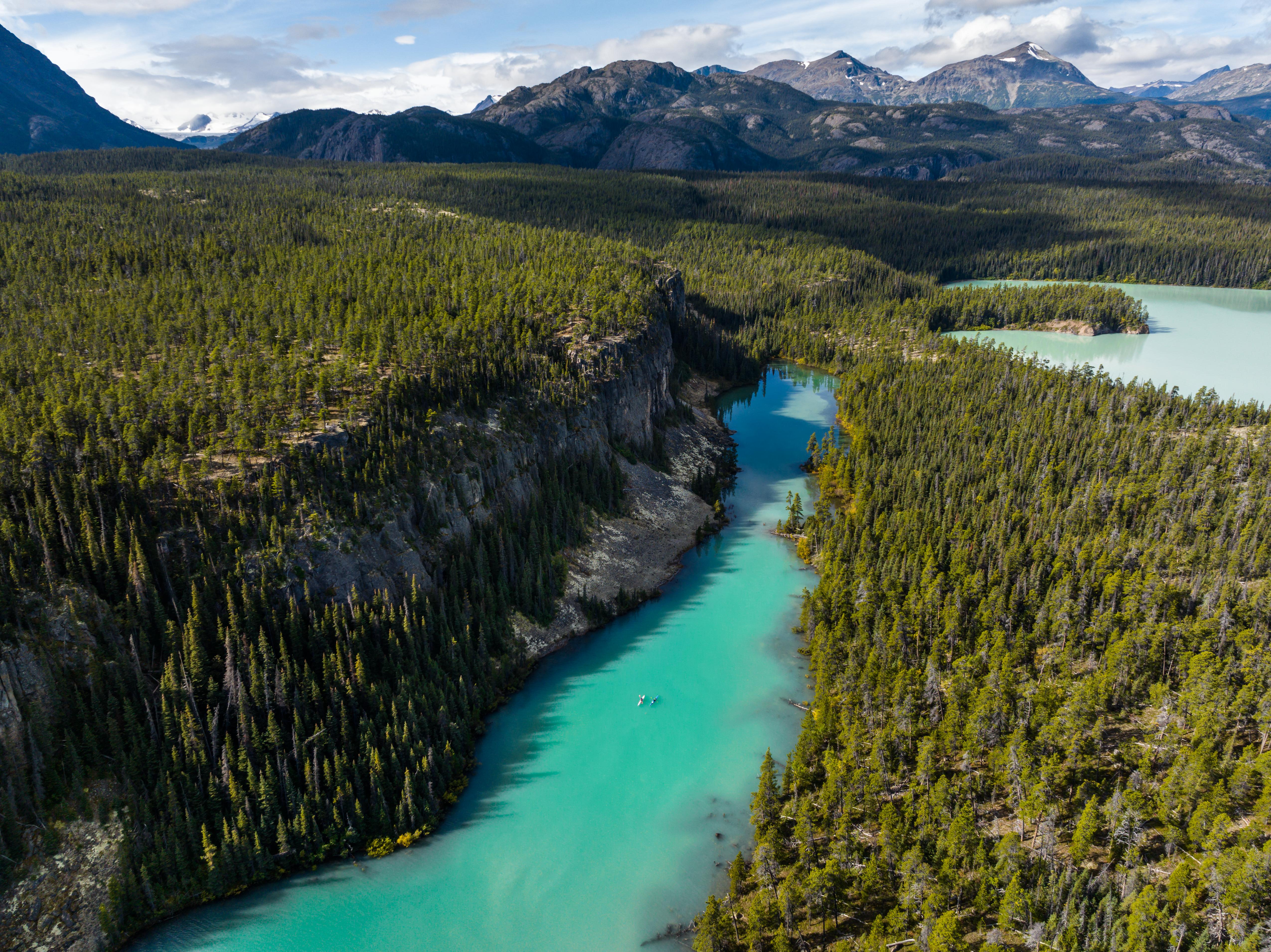A large open valley with a turquoise blue river running through