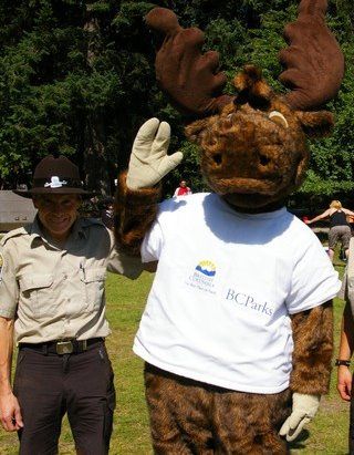 Park visitor takes photo with Jerry the Moose