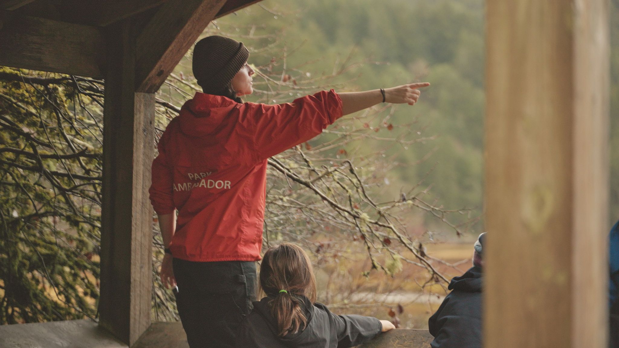 Discover Parks Ambassador points at an object at Goldstream Park