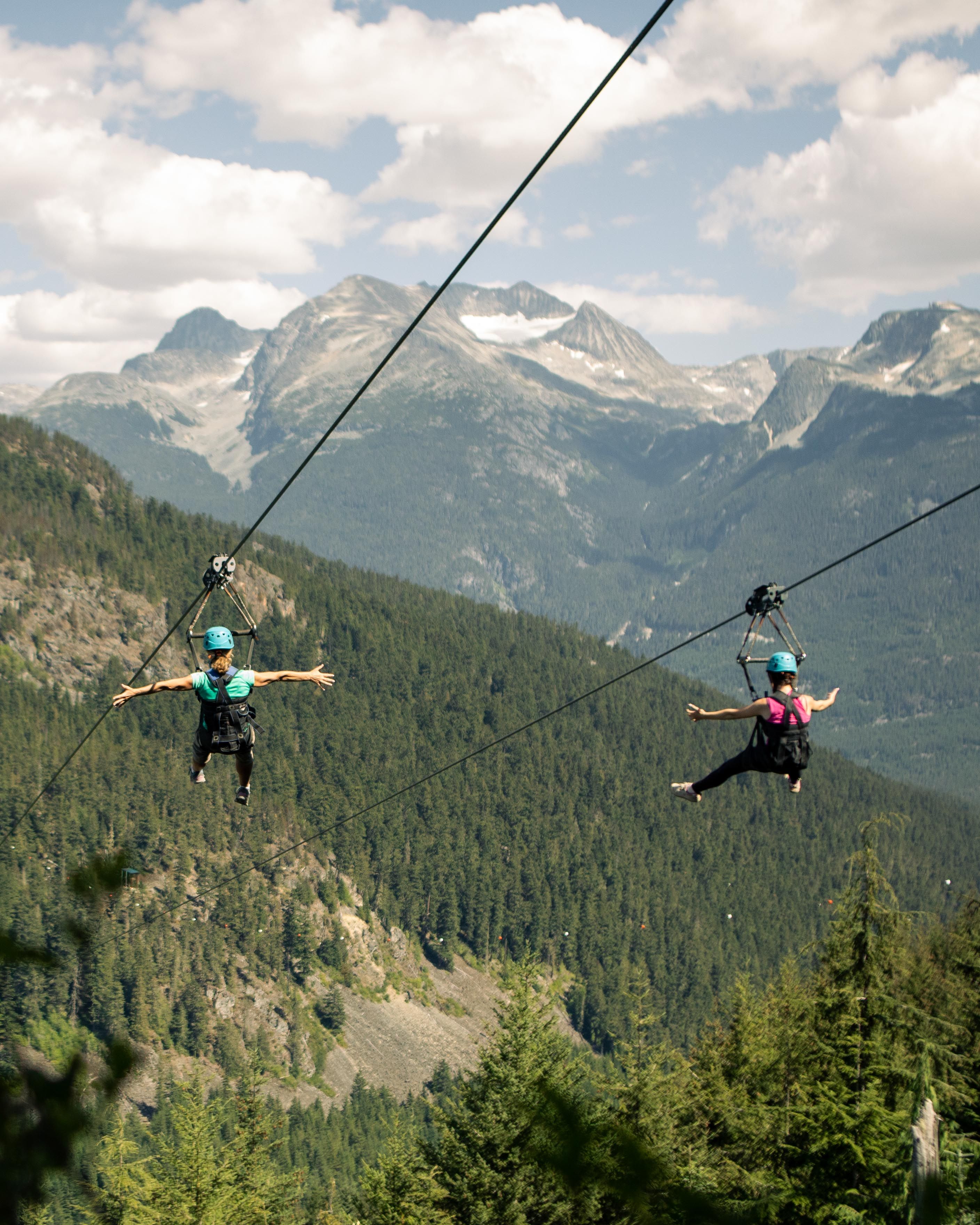 Two people on a zipline