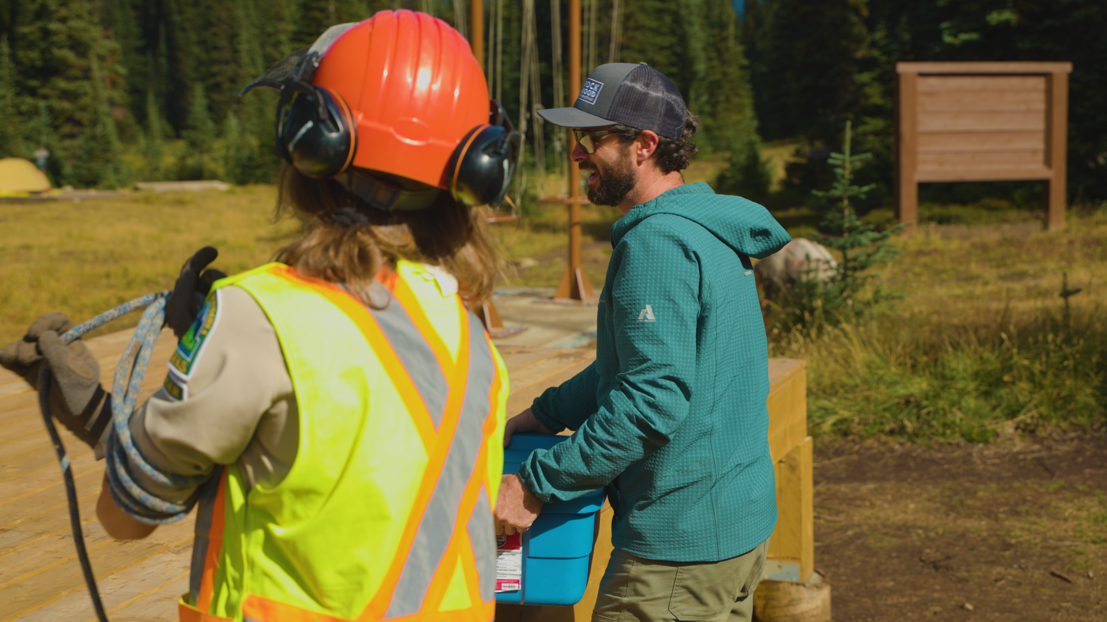 A group of people work on a new outhouse