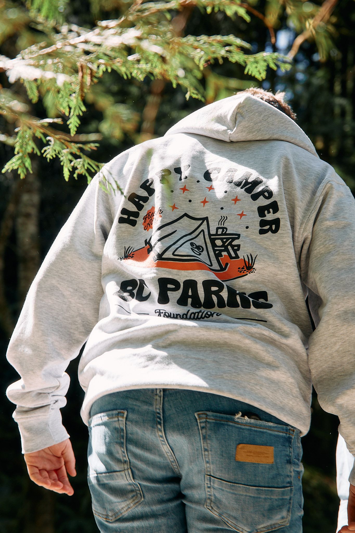 Person wears Happy Camper hoodie