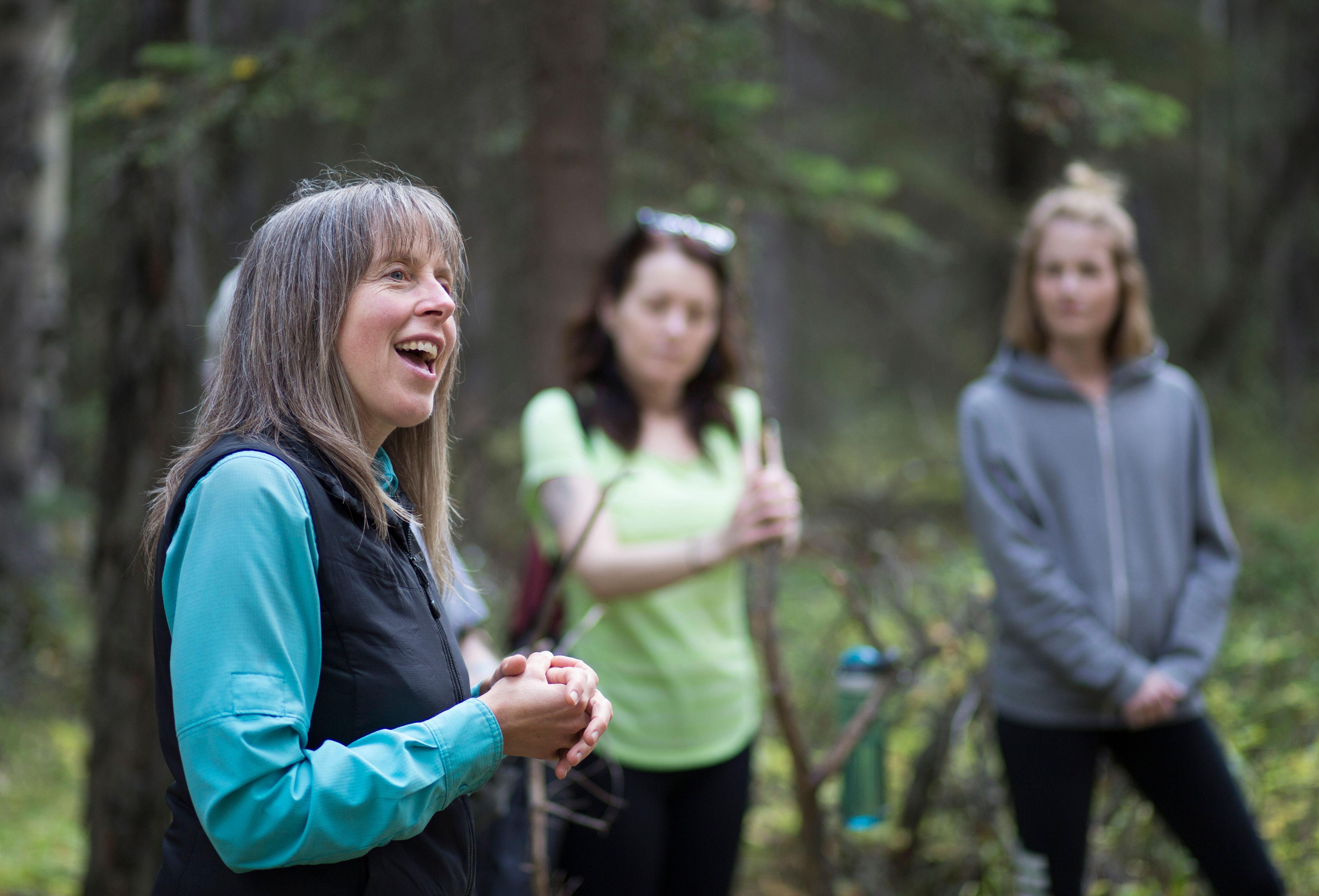Three people standing in forest. Courtesy of Nature and Forest Therapy of Canada.