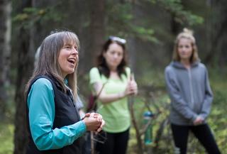 Three people standing in forest. Courtesy of Nature and Forest Therapy of Canada.