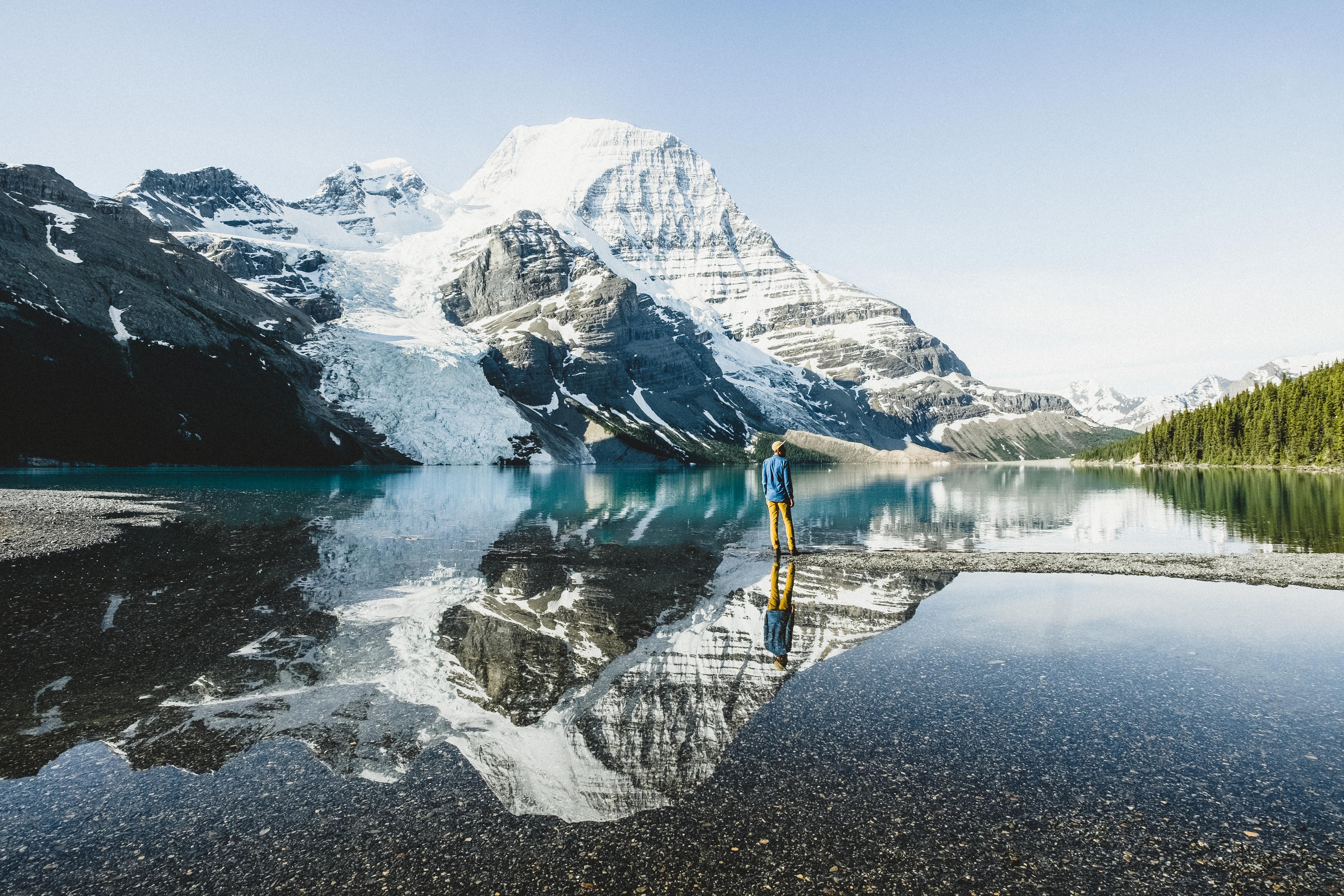 A person stands surrounded by glaciers in a snowy scene