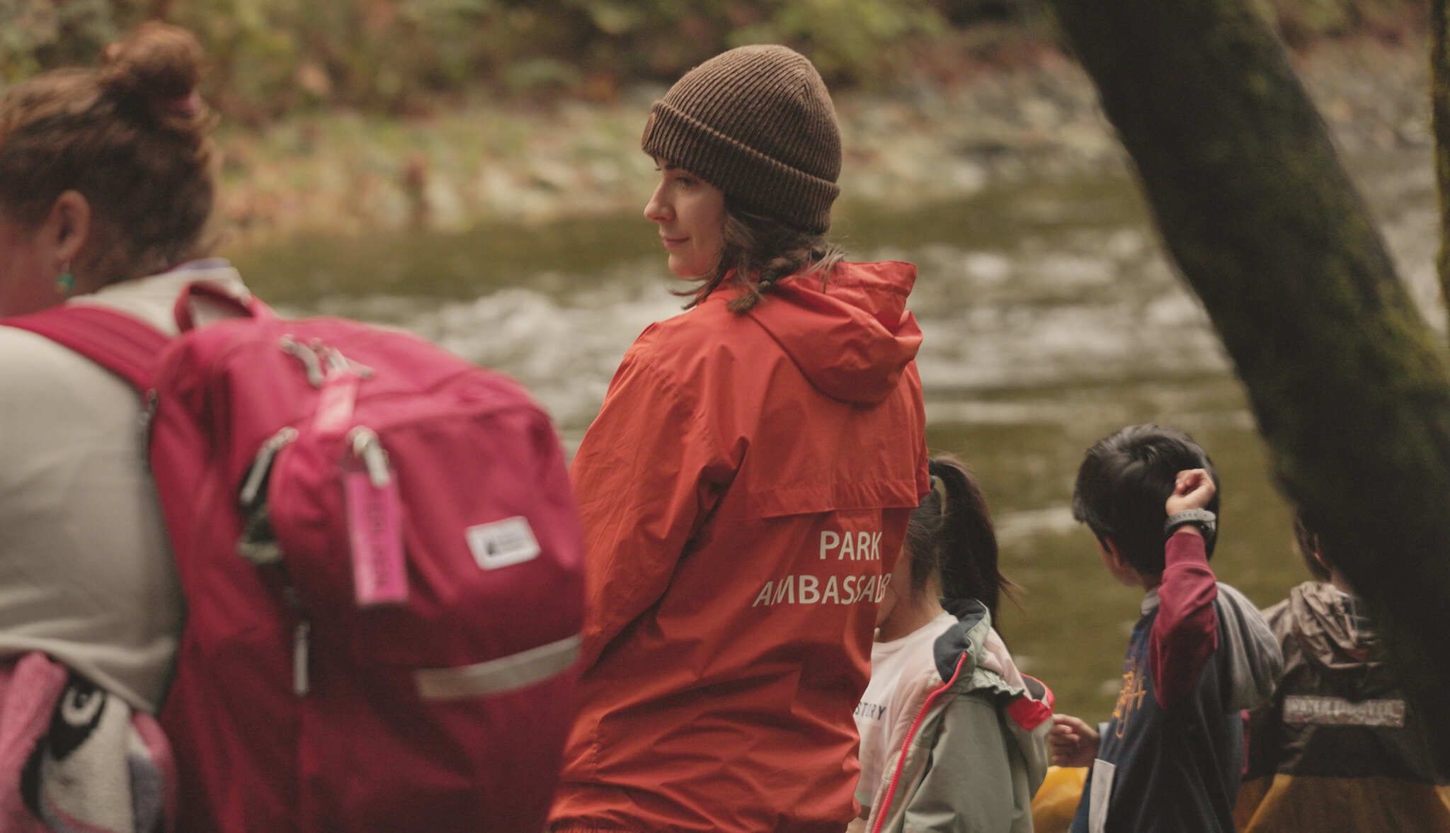 DPA, teacher, and children look at Goldstream River