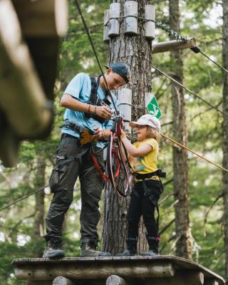 Adult and child on high-ropes course.