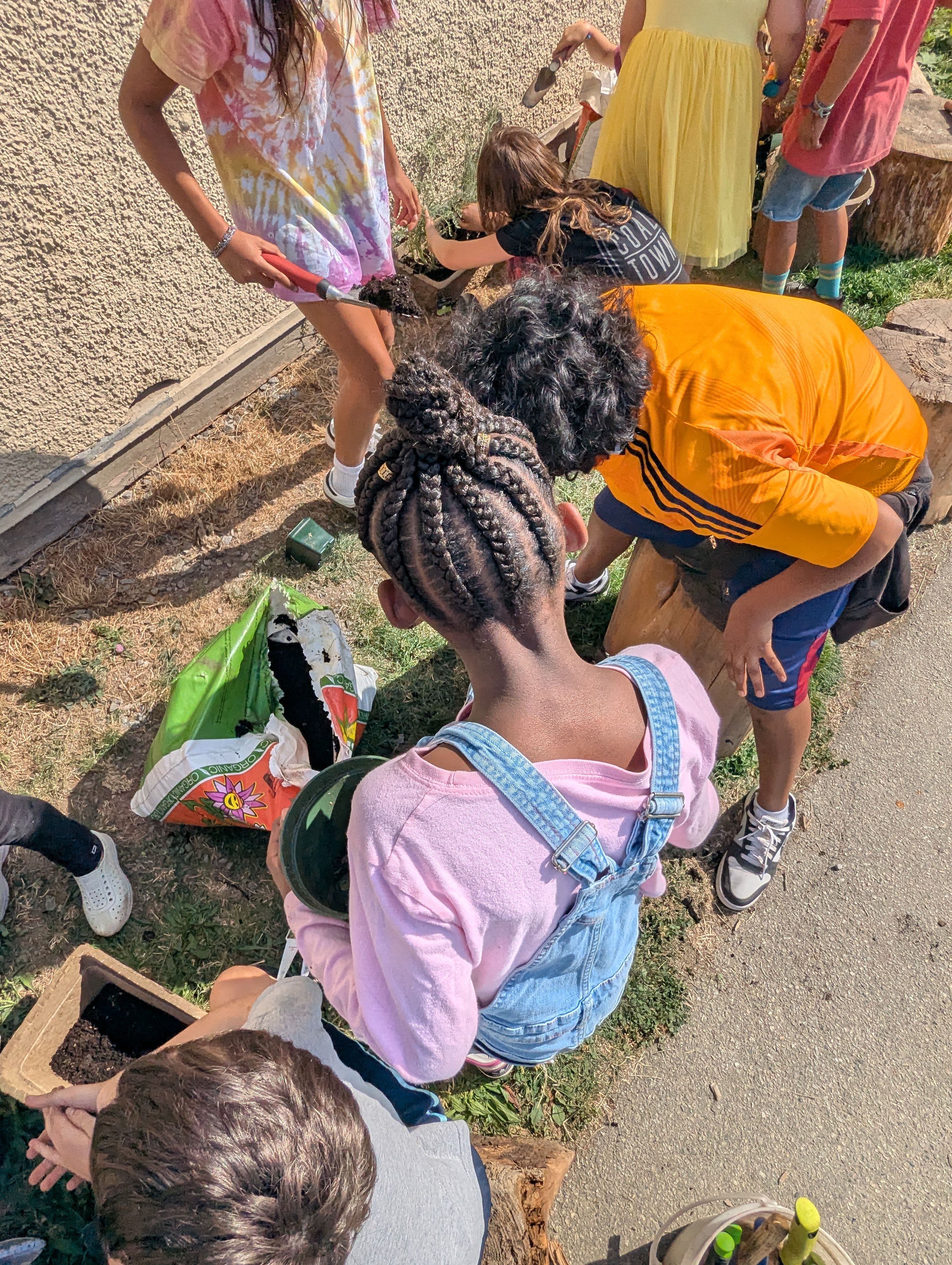 Students learning by nature through gardening on school grounds