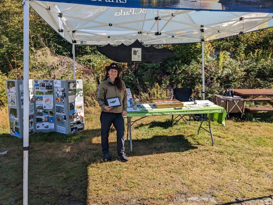 Woman shares information while standing at a booth