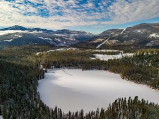 Rosebud Lake with forest and mountains in background