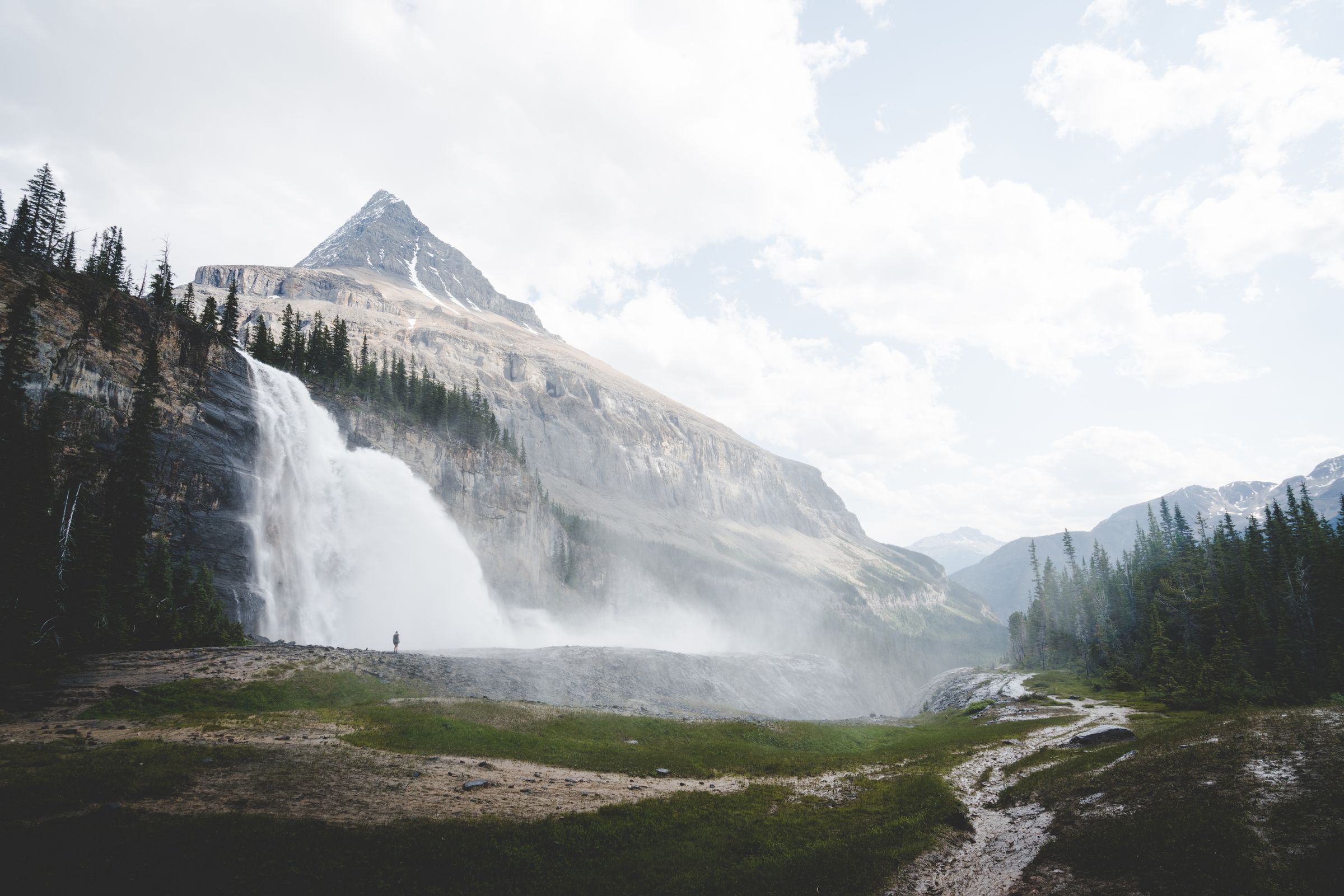 A hiker takes in the majestic beauty of Emperor Falls on the Berg Lake Trail in Mount Robson Park
