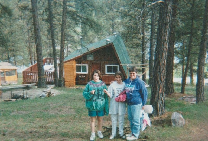 Children in front of wood cabin