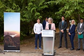 The Honourable Julie Dabrusin speaks behind a podium.