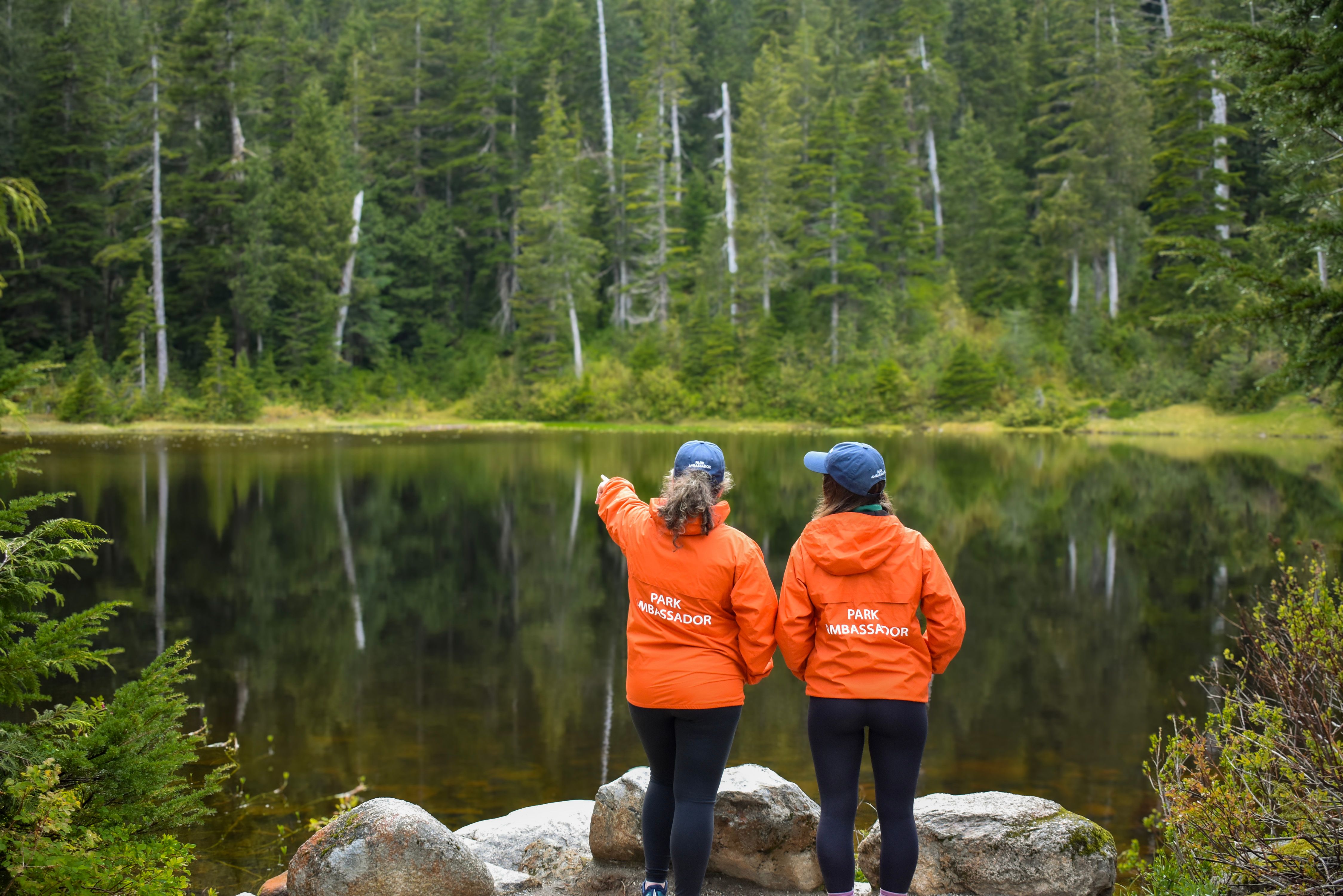 Two Discover Parks Ambassadors standing by a lake.