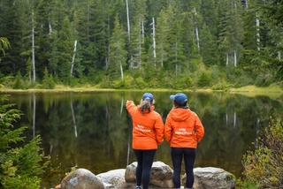 Two Discover Parks Ambassadors standing by a lake.