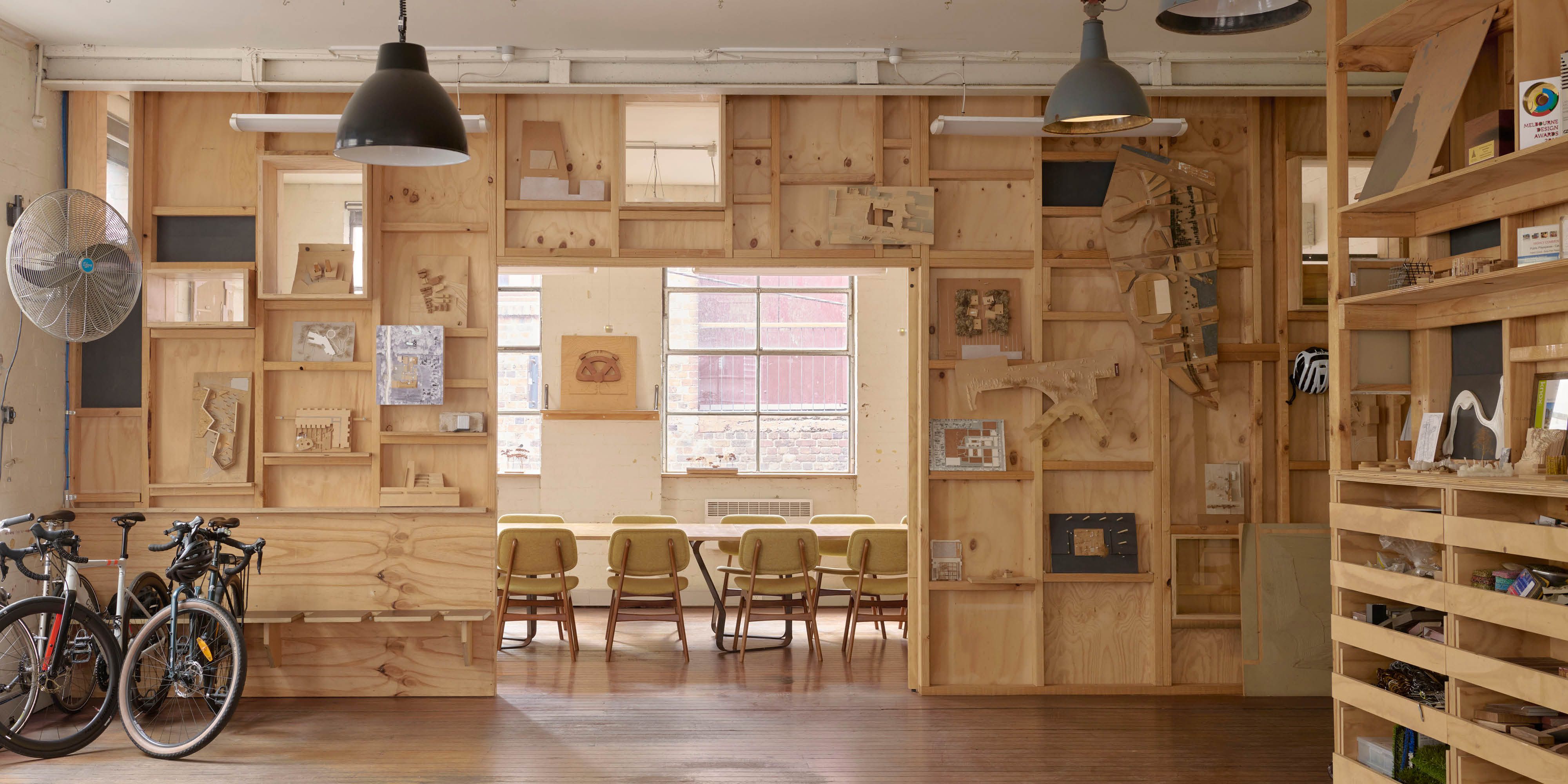 Plywood walls contain model designs, with bikes sitting in the corner of the room.