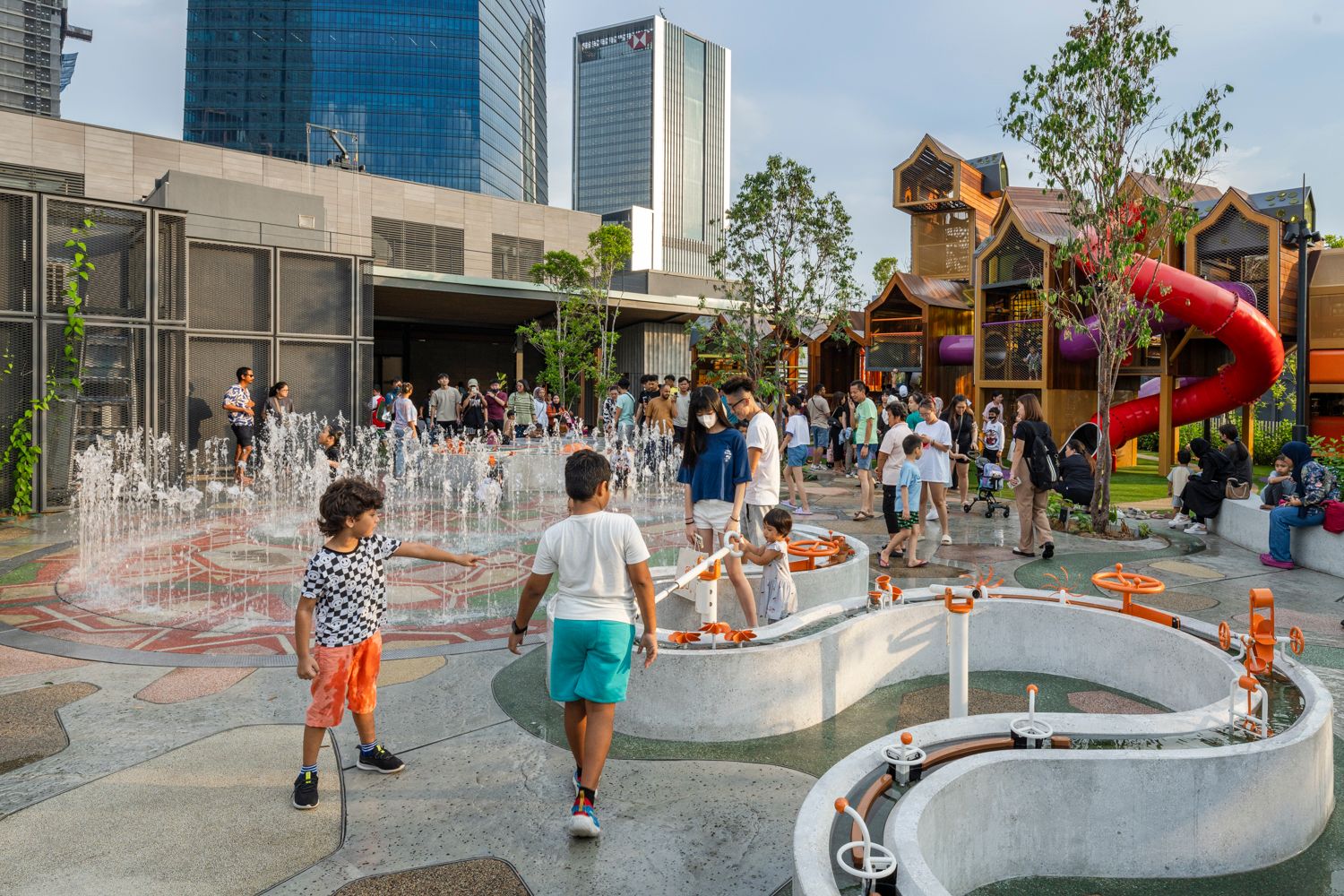 A photo of a busy playground with lots of water play activities.