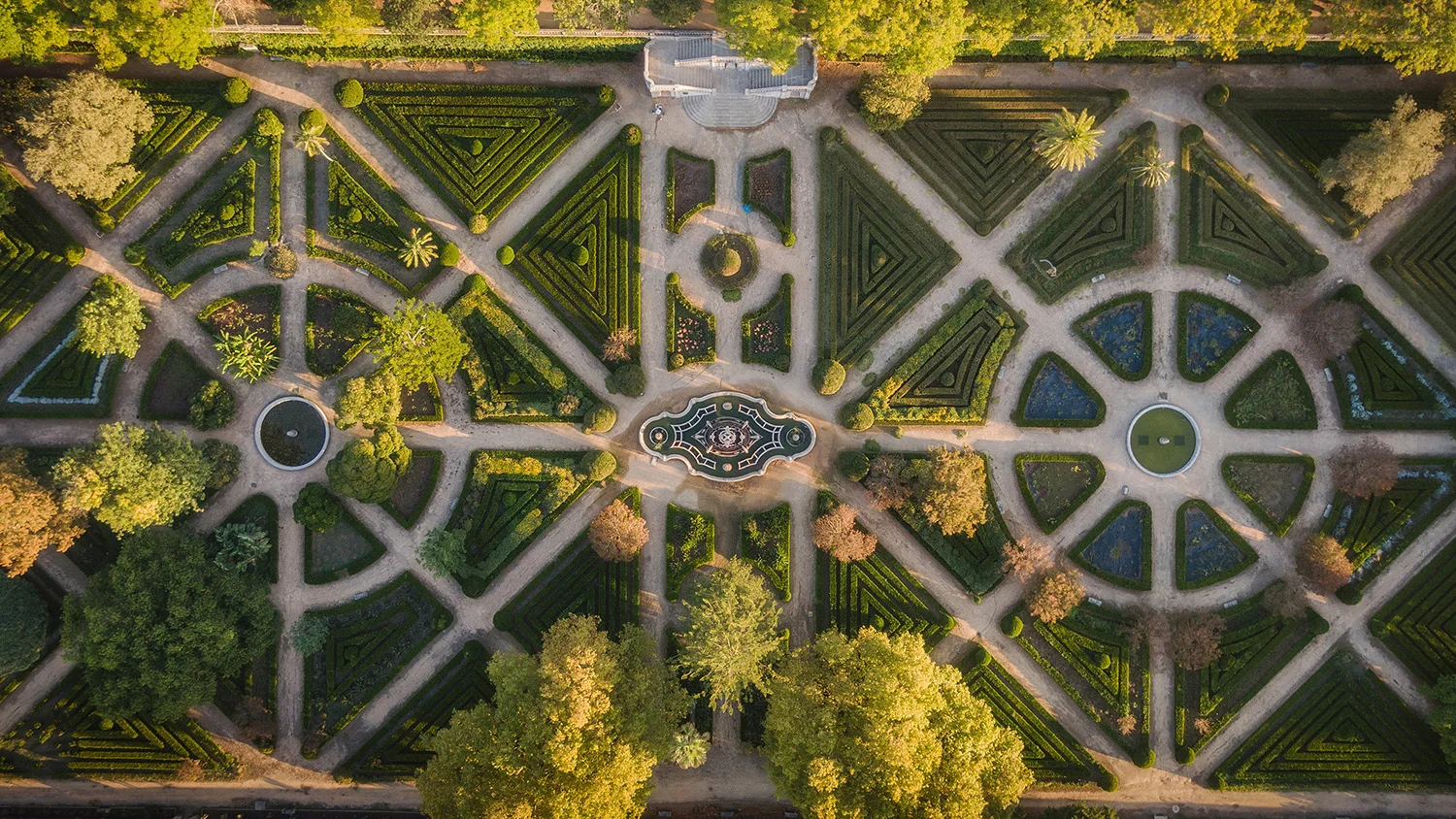 Aerial shot of elaborate botanical gardens with multiple symmetrical pathways