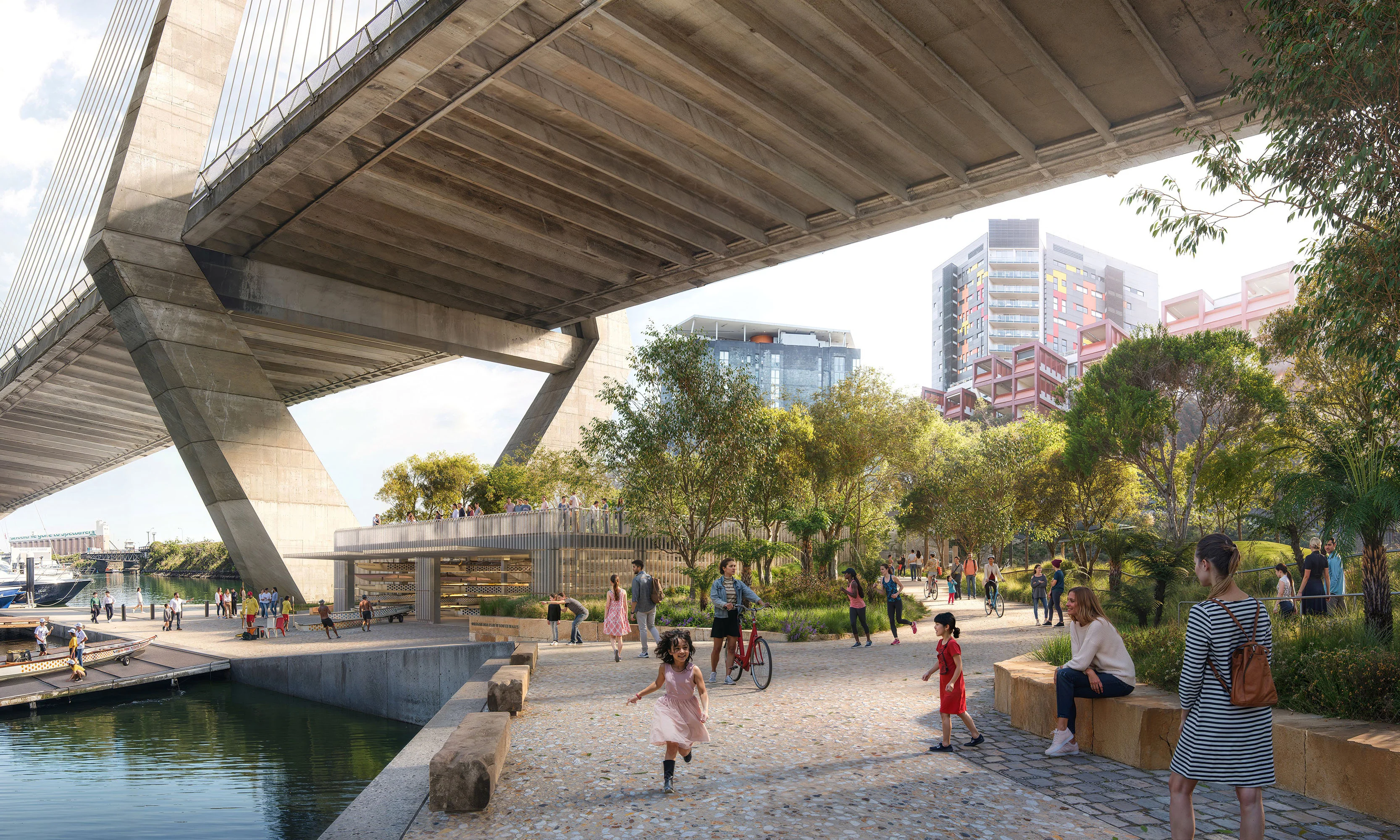 A digital render of a waterfront park filled with trees and people. The park is under a large concrete bridge, and a boat shed with ramp is visible.