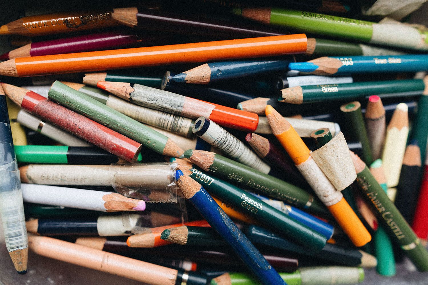 A photograph of a jumble of well-used coloured pencils.
