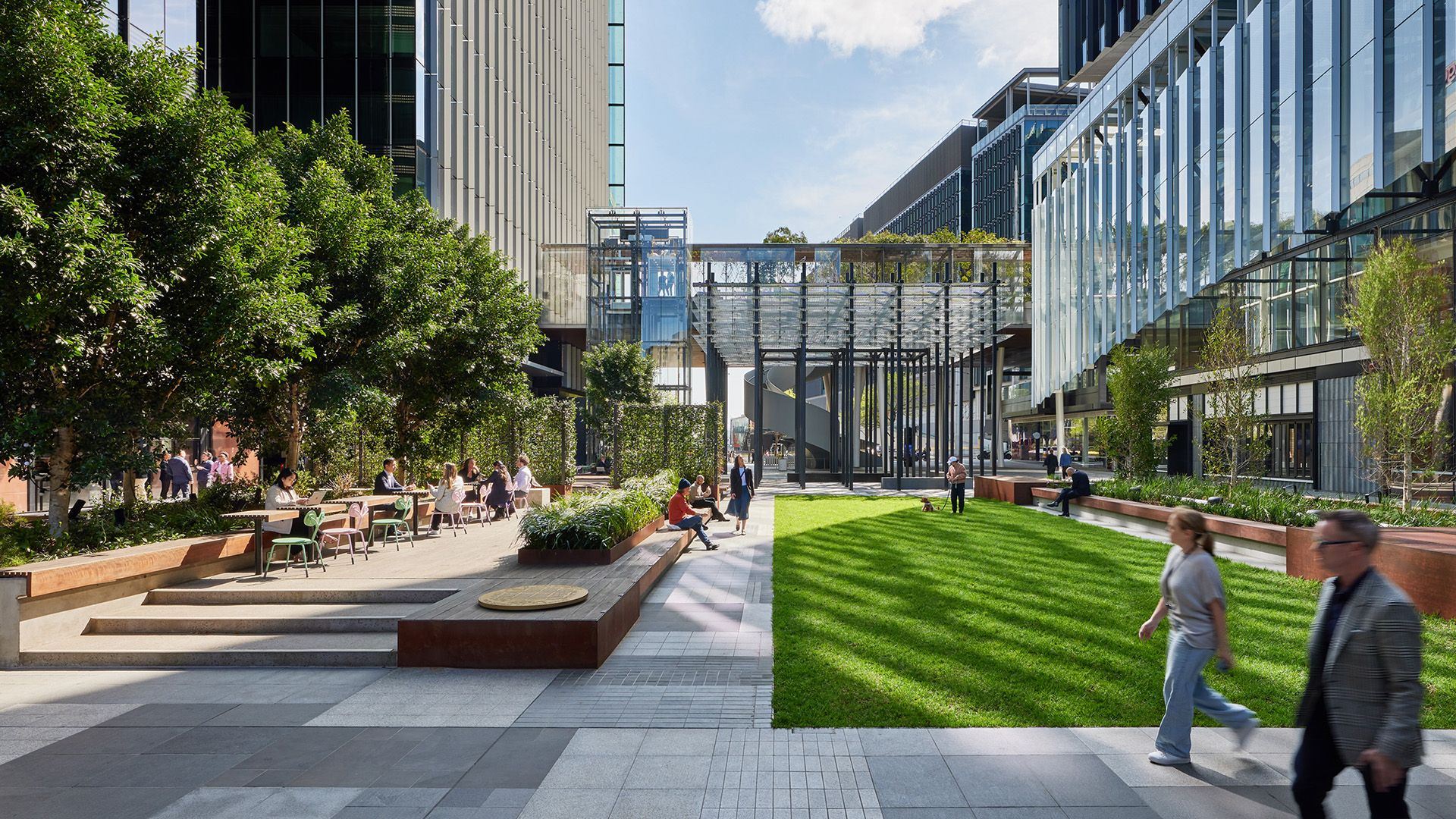 Stylised render of people walking through a city courtyard on a sunny day.