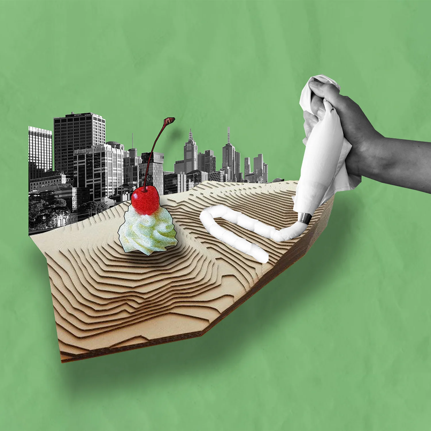 A collage of an urban landscape, decorated like a cake. The background is green paper.