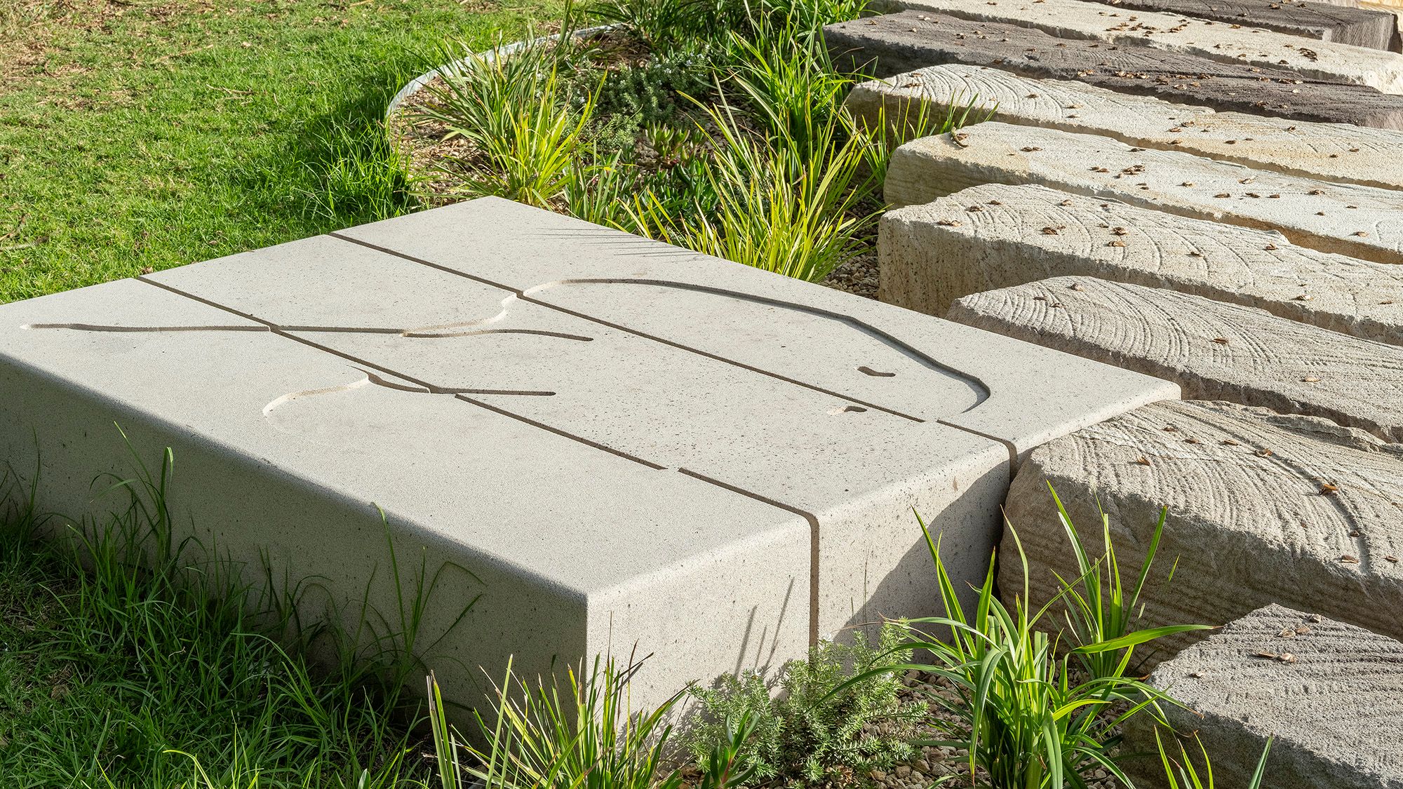Polished stone with contoured artwork forming part of the revetment wall.