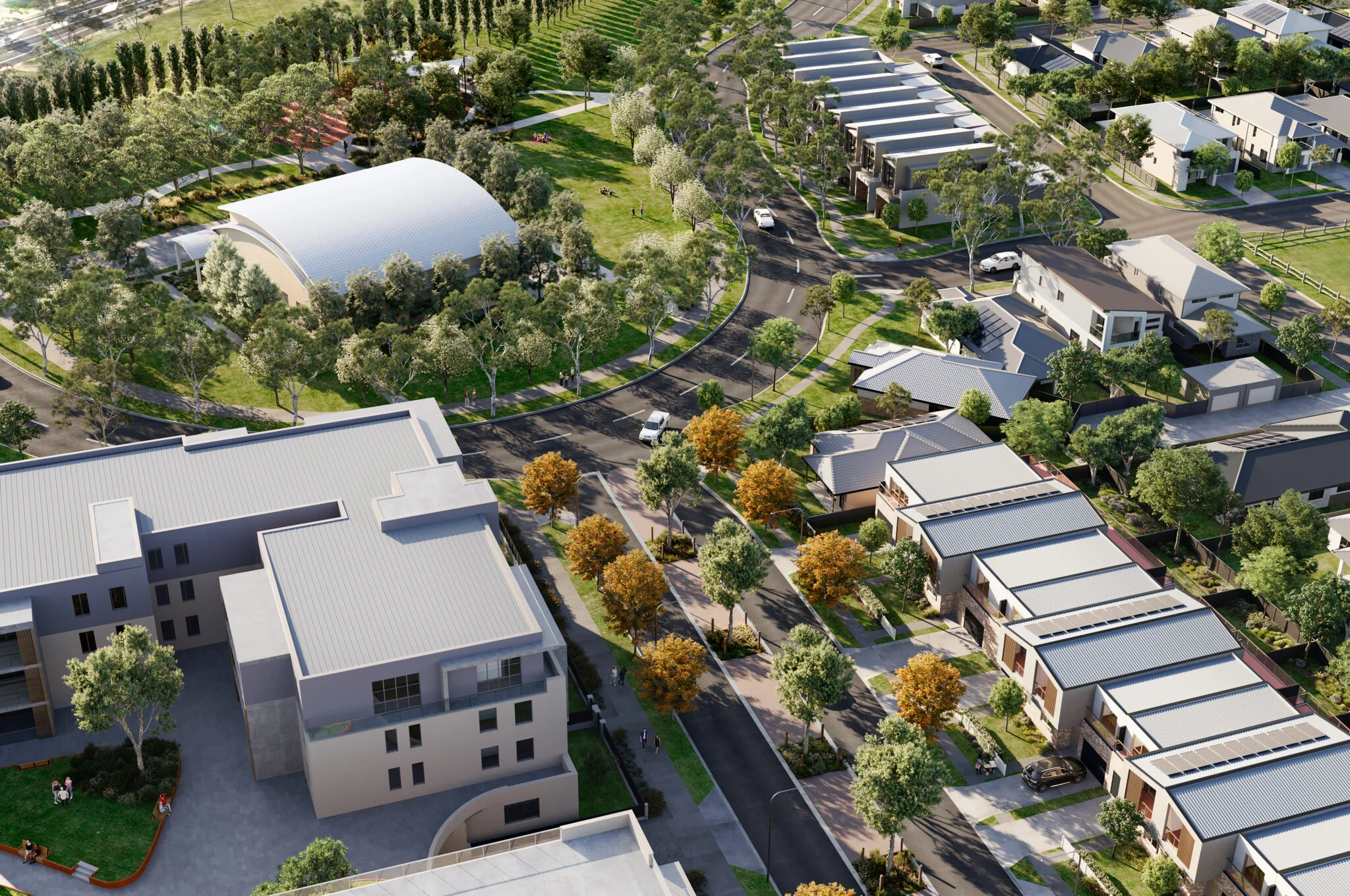 A digital render of a new residential community from above. There is an apartment building, townhouses, open space, and lots of trees.