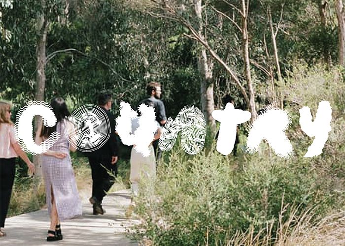 A photograph of five people walking along a path on Country. Illustrated, organic, white text over the image reads 'Country'.