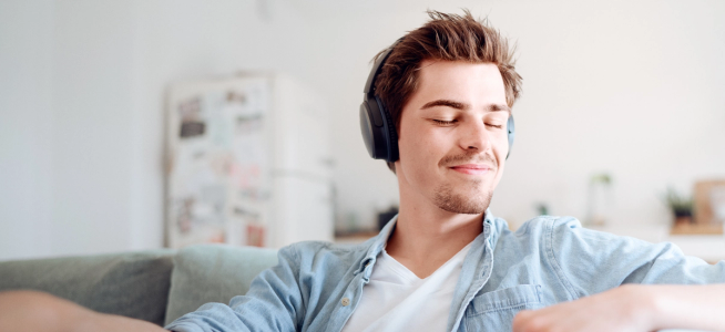 Young man sitting on sofa and relaxing